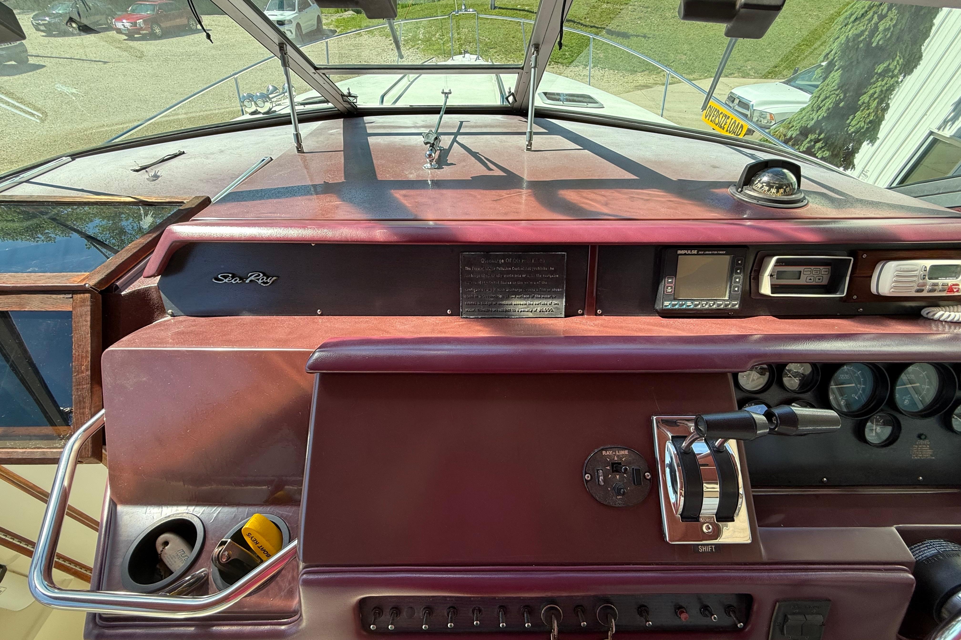 1990 Sea Ray 310 Express Cruiser helm with controls and navigation instruments.