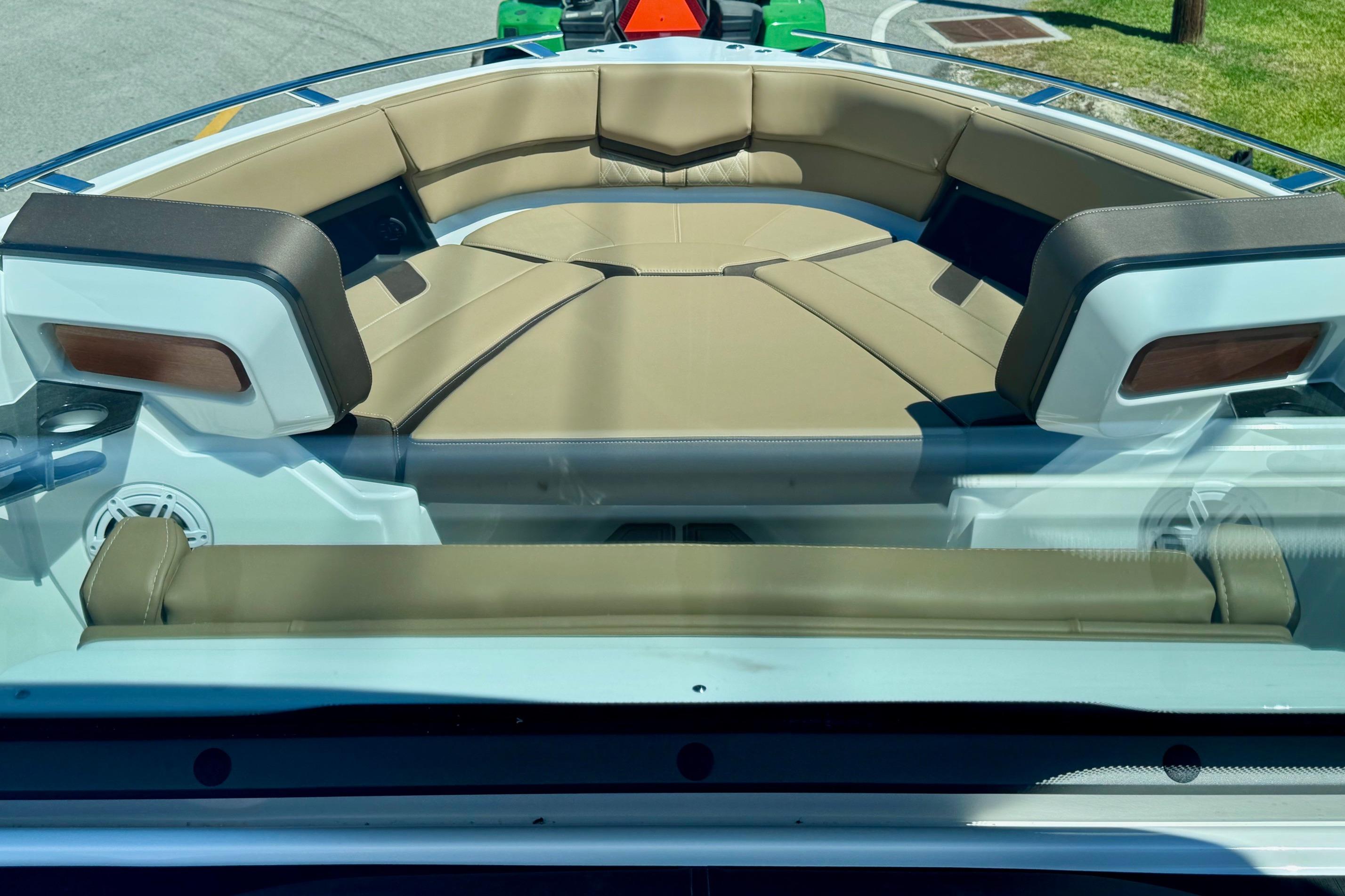 Luxurious seating on the 2026 Monterey Elite 27 OB boat, featuring tan upholstery.