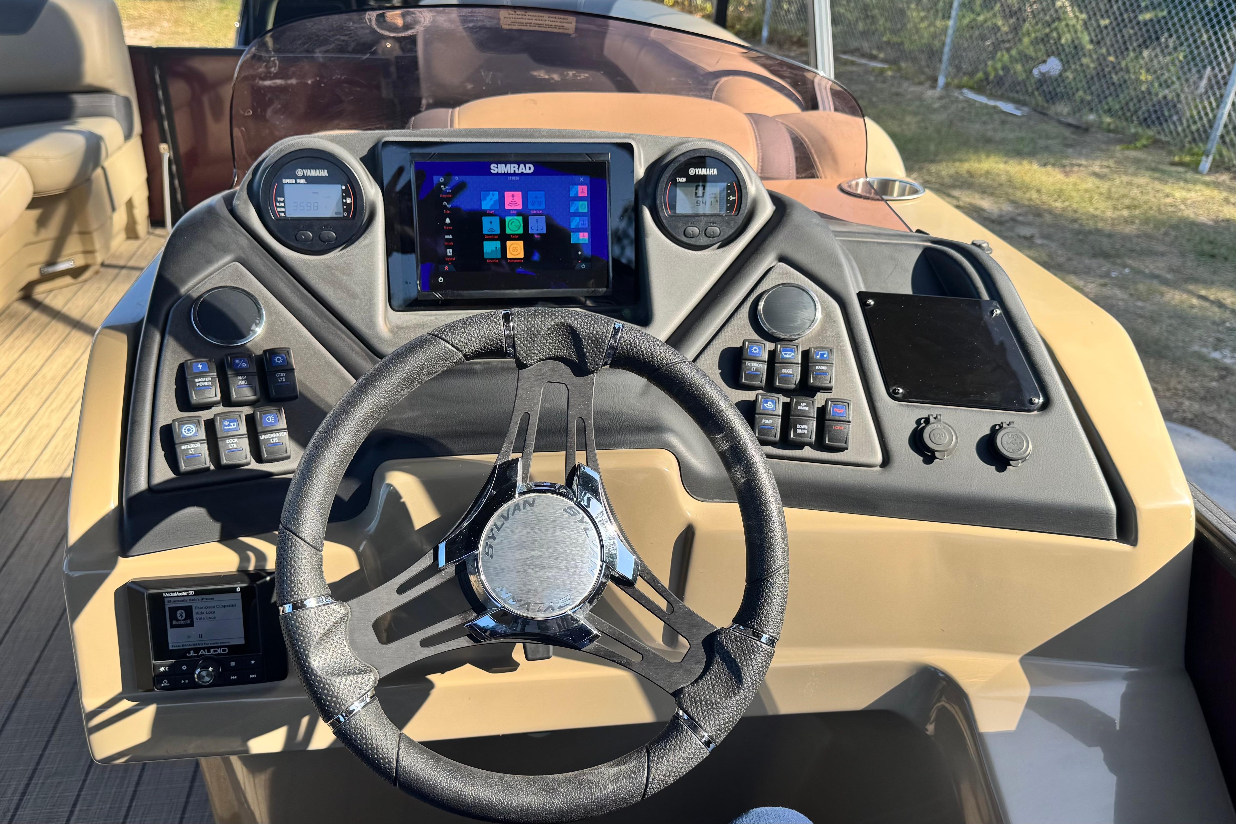 2023 Sylvan L5 CLZ boat dashboard with steering wheel and control panel.