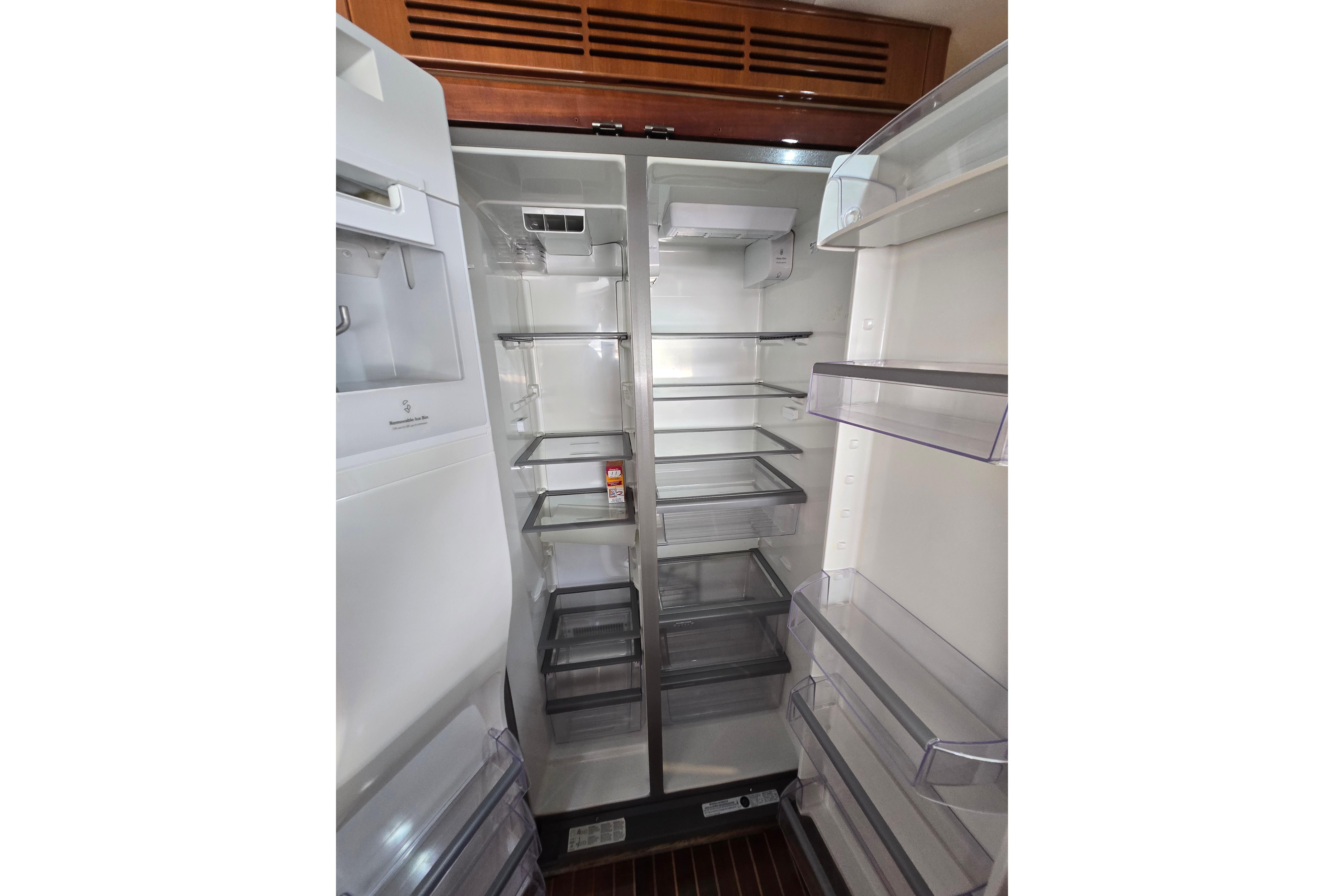 Empty refrigerator interior on a 2004 Grand Harbour 58 yacht, showcasing spacious shelving.