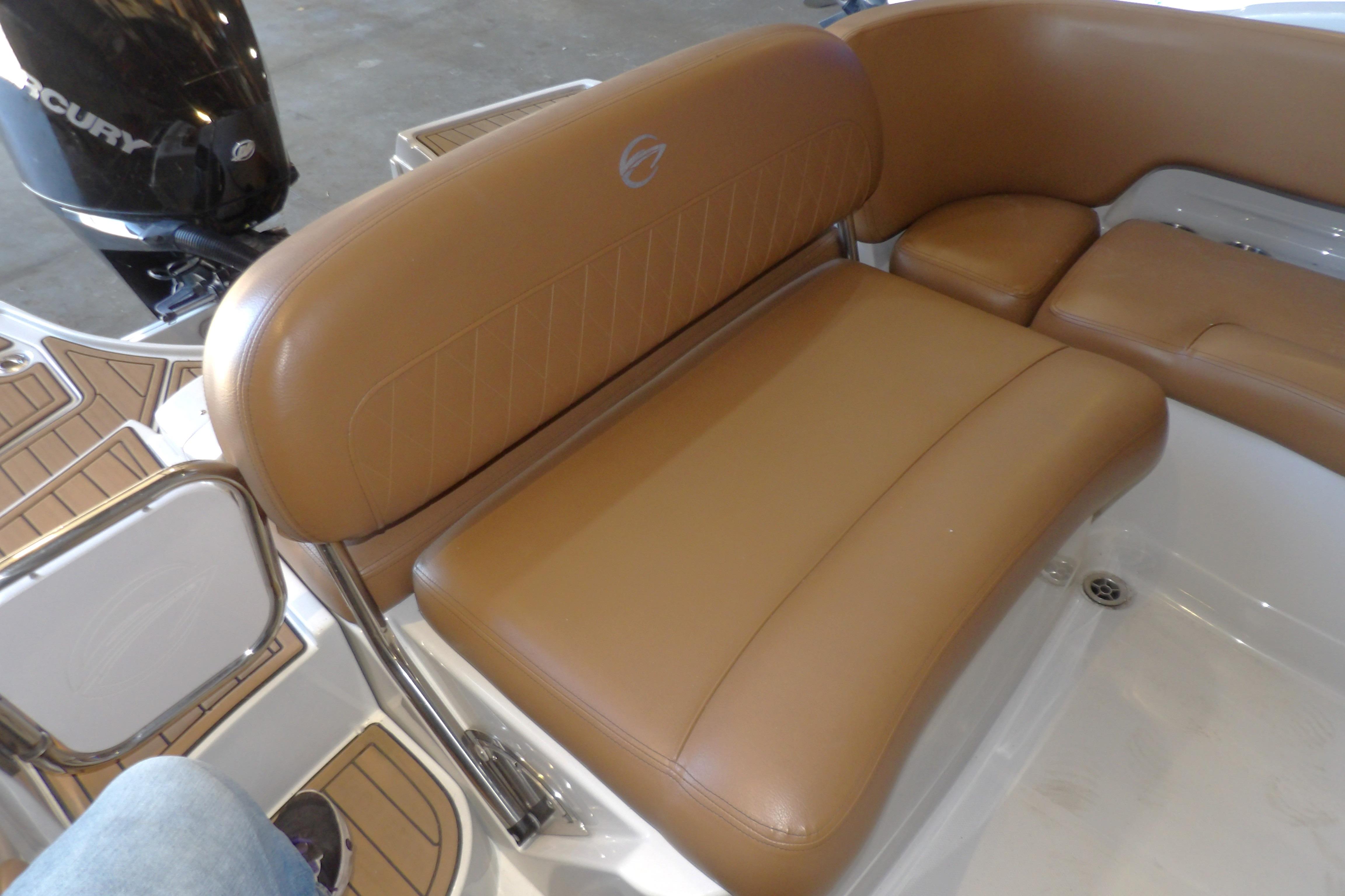 2023 Crownline 250 XSS boat with tan leather seating and Mercury engine.