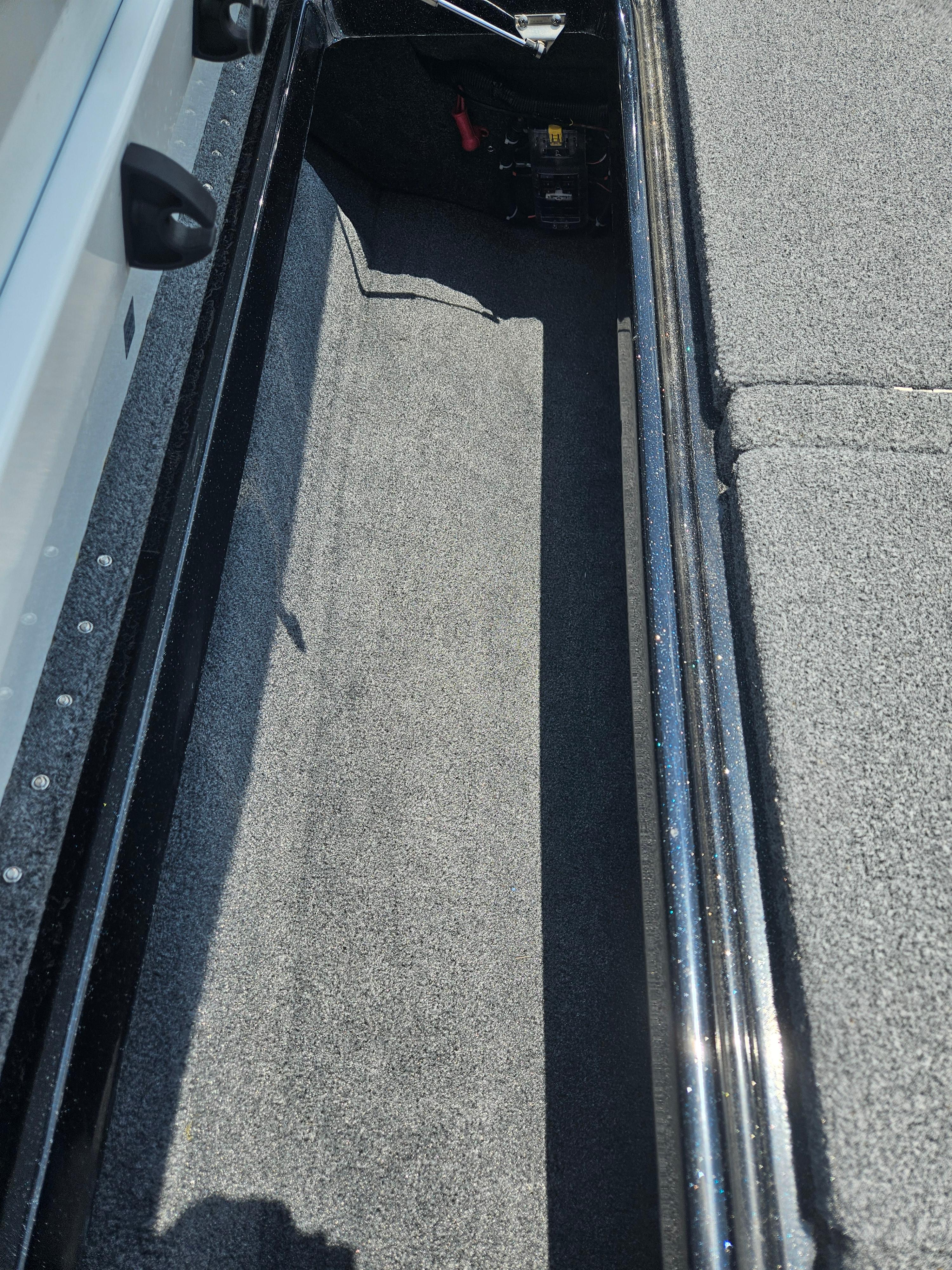 2023 Phoenix 721 ProXP boat storage compartment with carpeted interior.