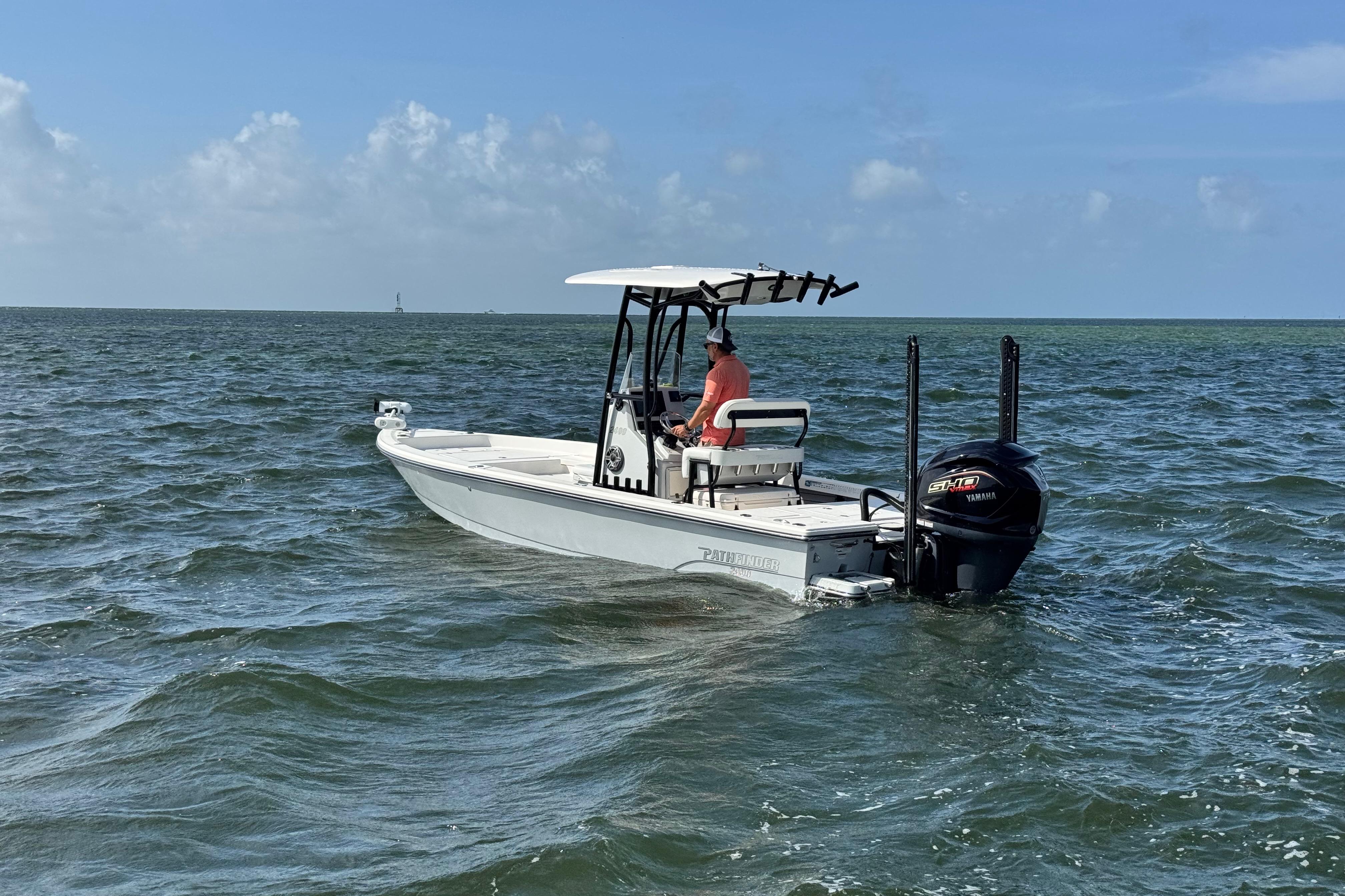 2022 Pathfinder 2400 TRS boat cruising on open water under clear skies.