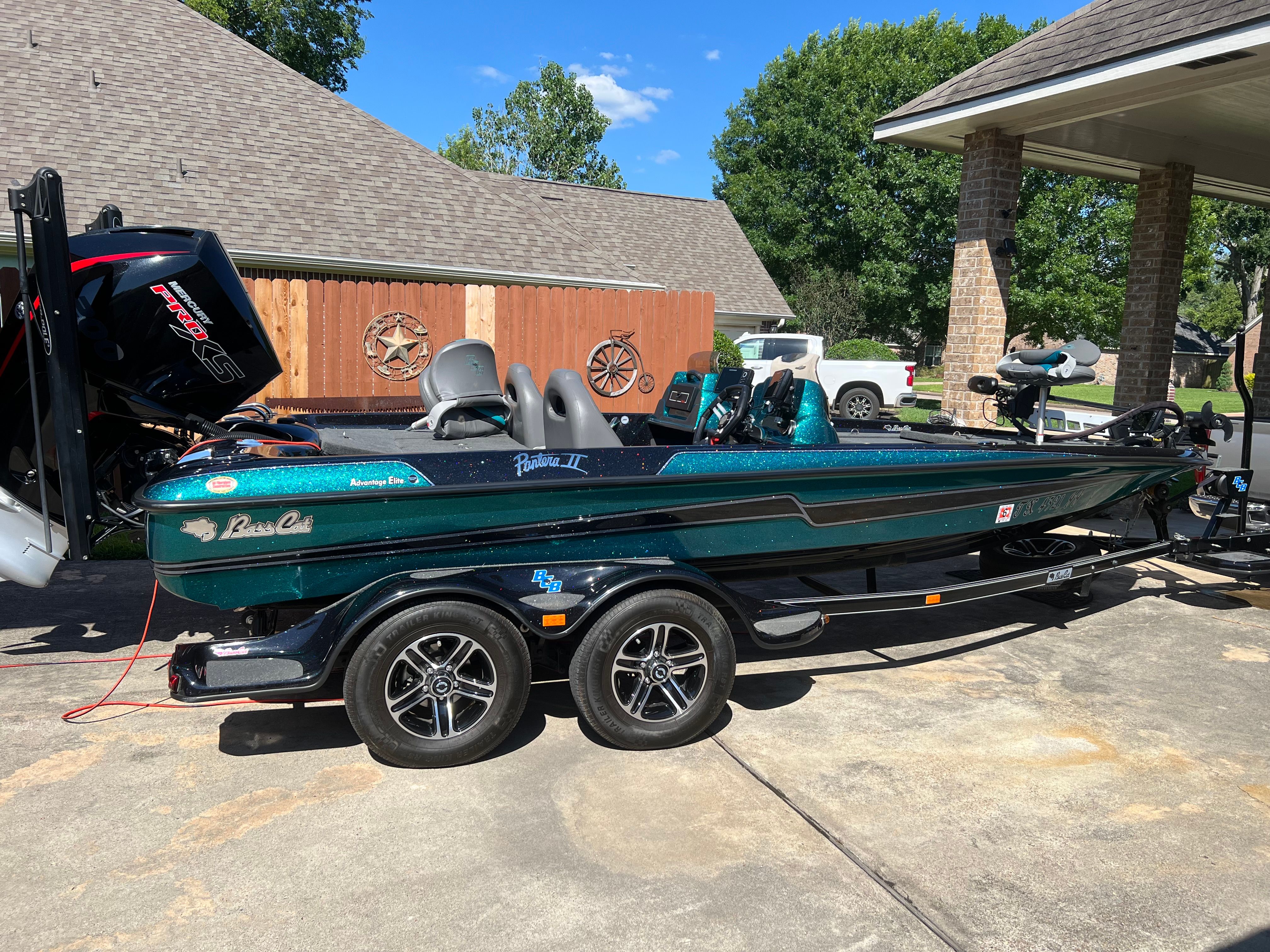 A 2020 Bass Cat Pantera II boat on a trailer in a driveway.