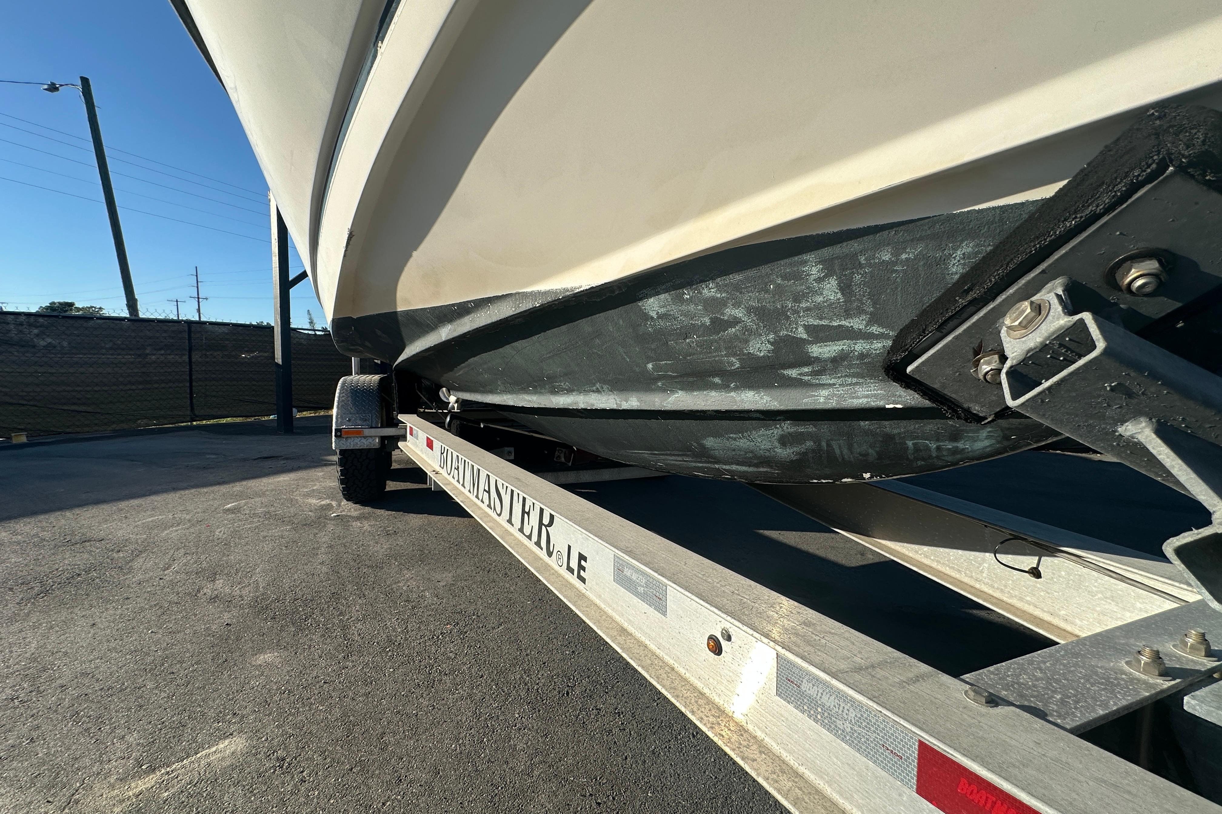 2001 Boston Whaler 23 Conquest boat on a trailer, side view.