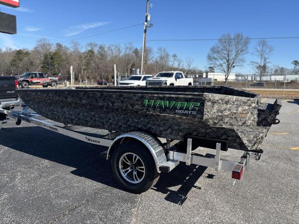 2025 Havoc 1656 VJST boat on trailer, camo design, parked outdoors.