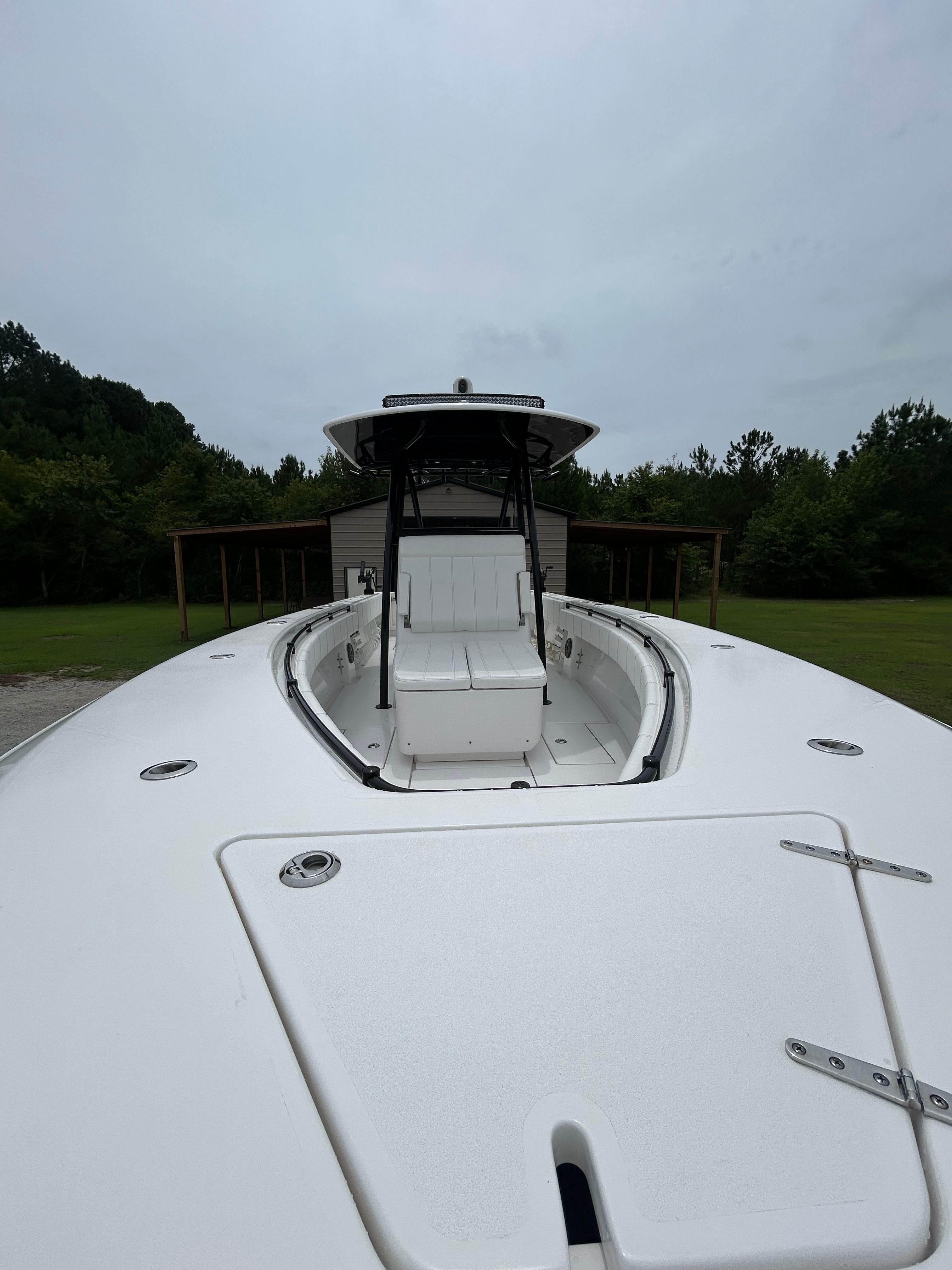 The image shows a 2023 Contender 30 ST boat with a spacious deck and seating area.