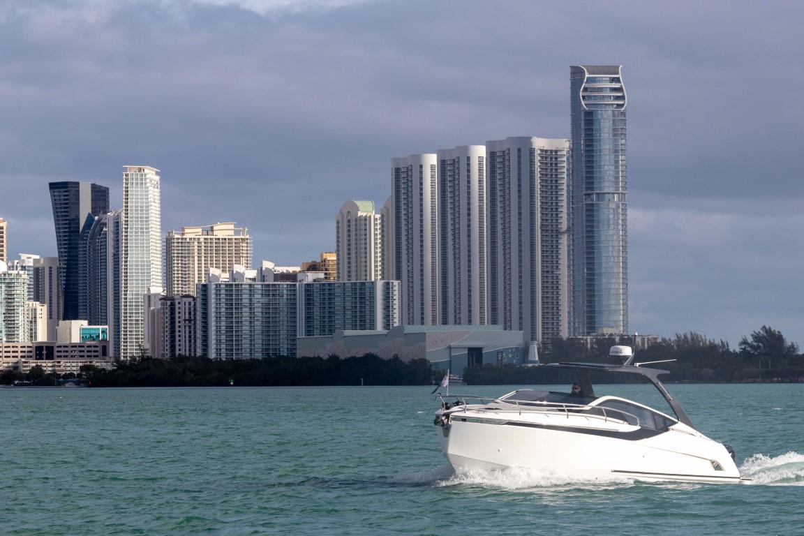 2023 Fairline F//Line 33 Outboard cruising near city skyline.