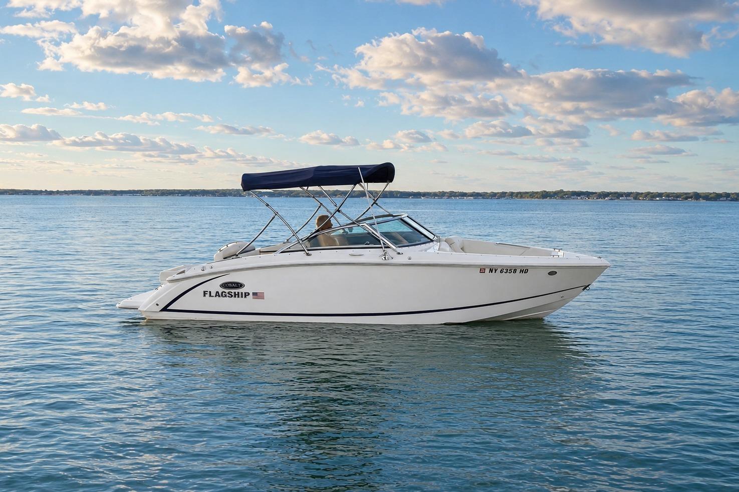 2019 Cobalt R3 boat on calm water under a partly cloudy sky.
