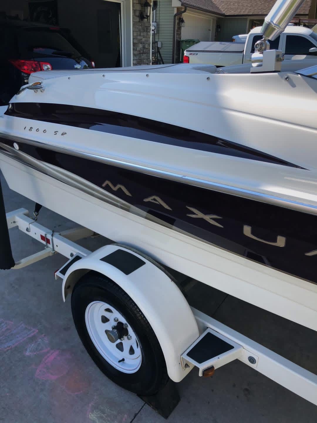 1999 Maxum 1800 SR boat on trailer in driveway.