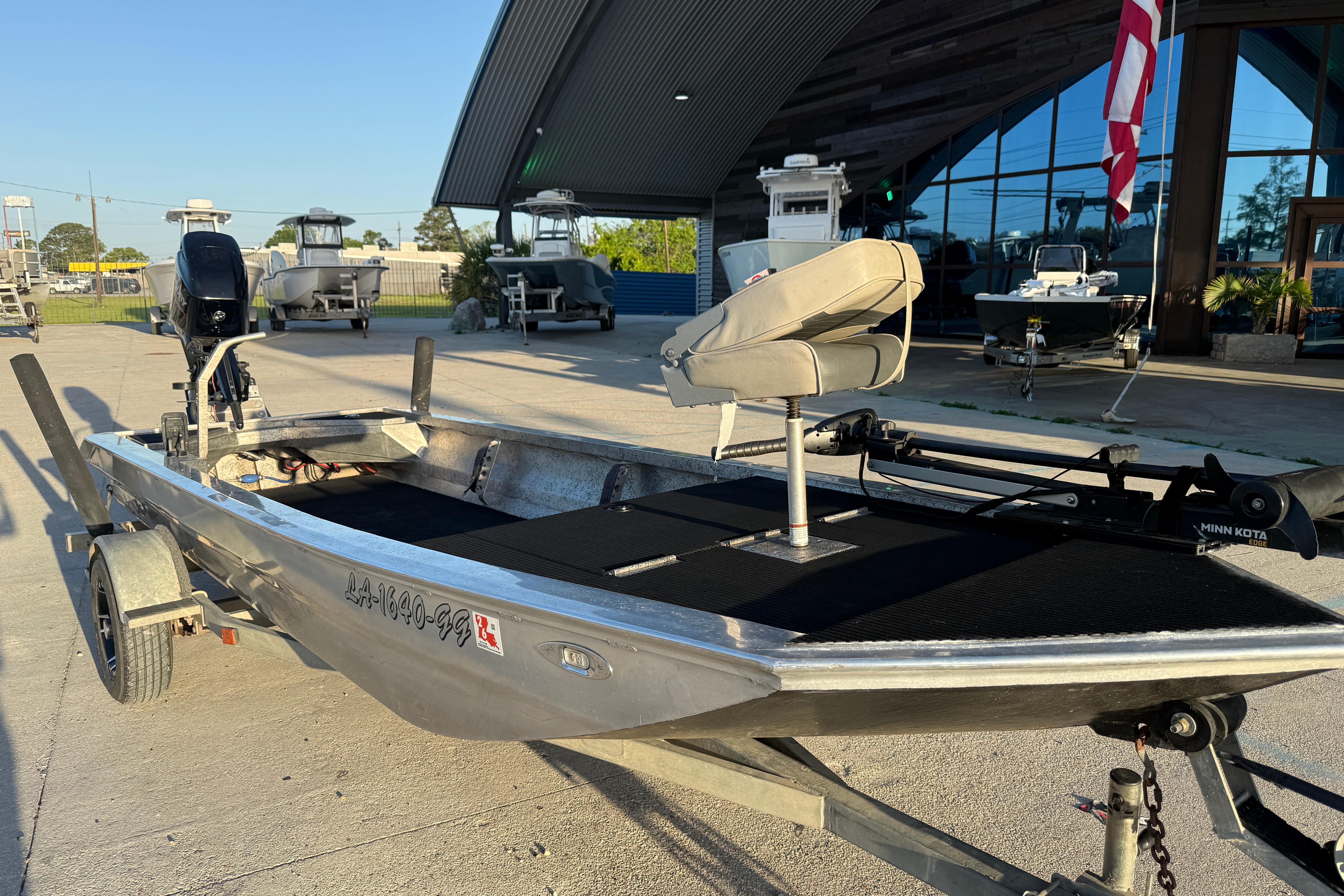 2017 Homemade 1754 boat with motor and seating, parked outdoors near a building.