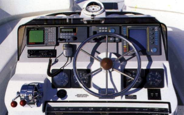 Dashboard of a 1996 Mainship 37 Motor Yacht with steering wheel and instruments.