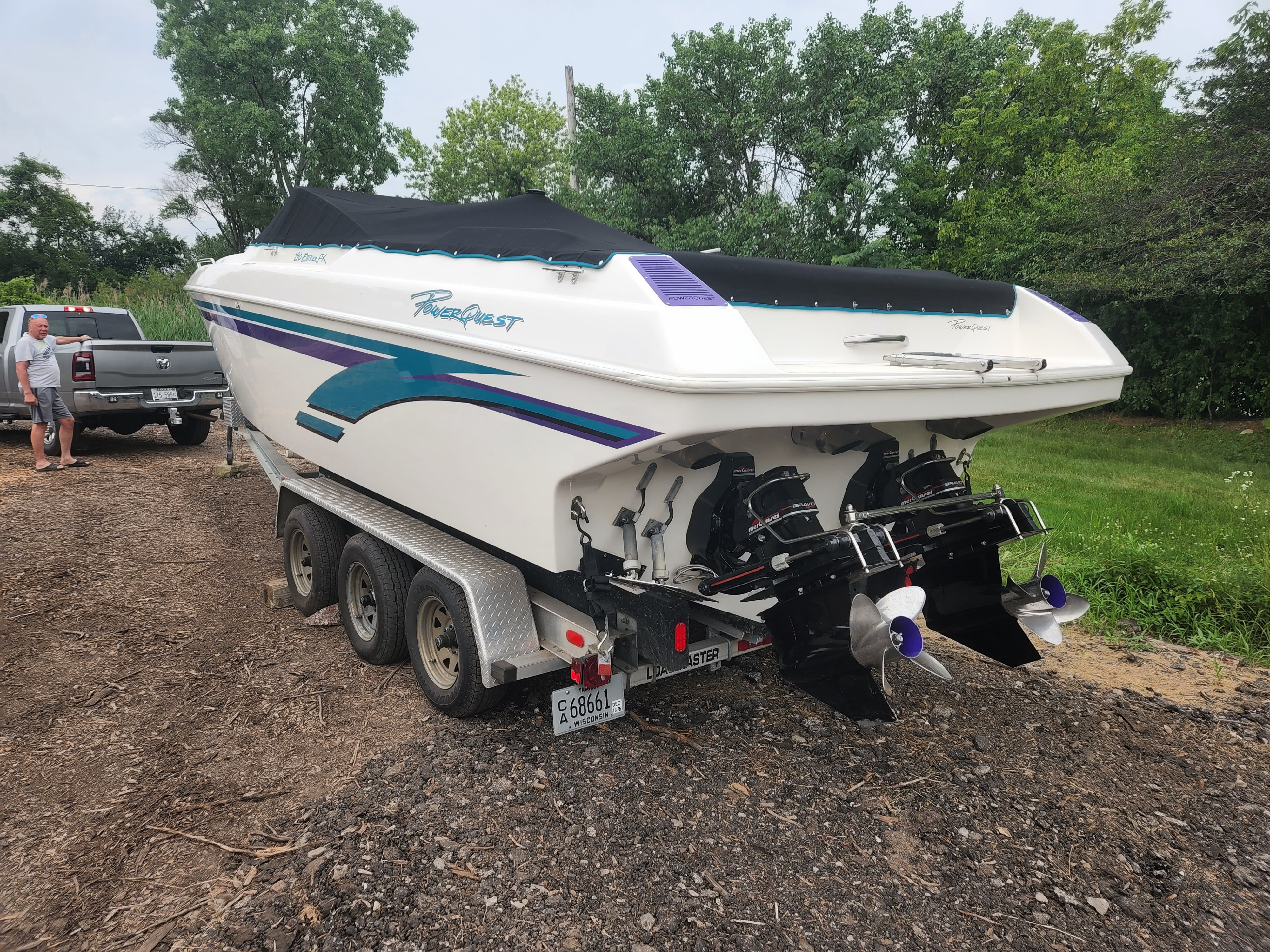 A 1998 Powerquest Enticer 290 FX on a trailer, featuring dual outboard engines.