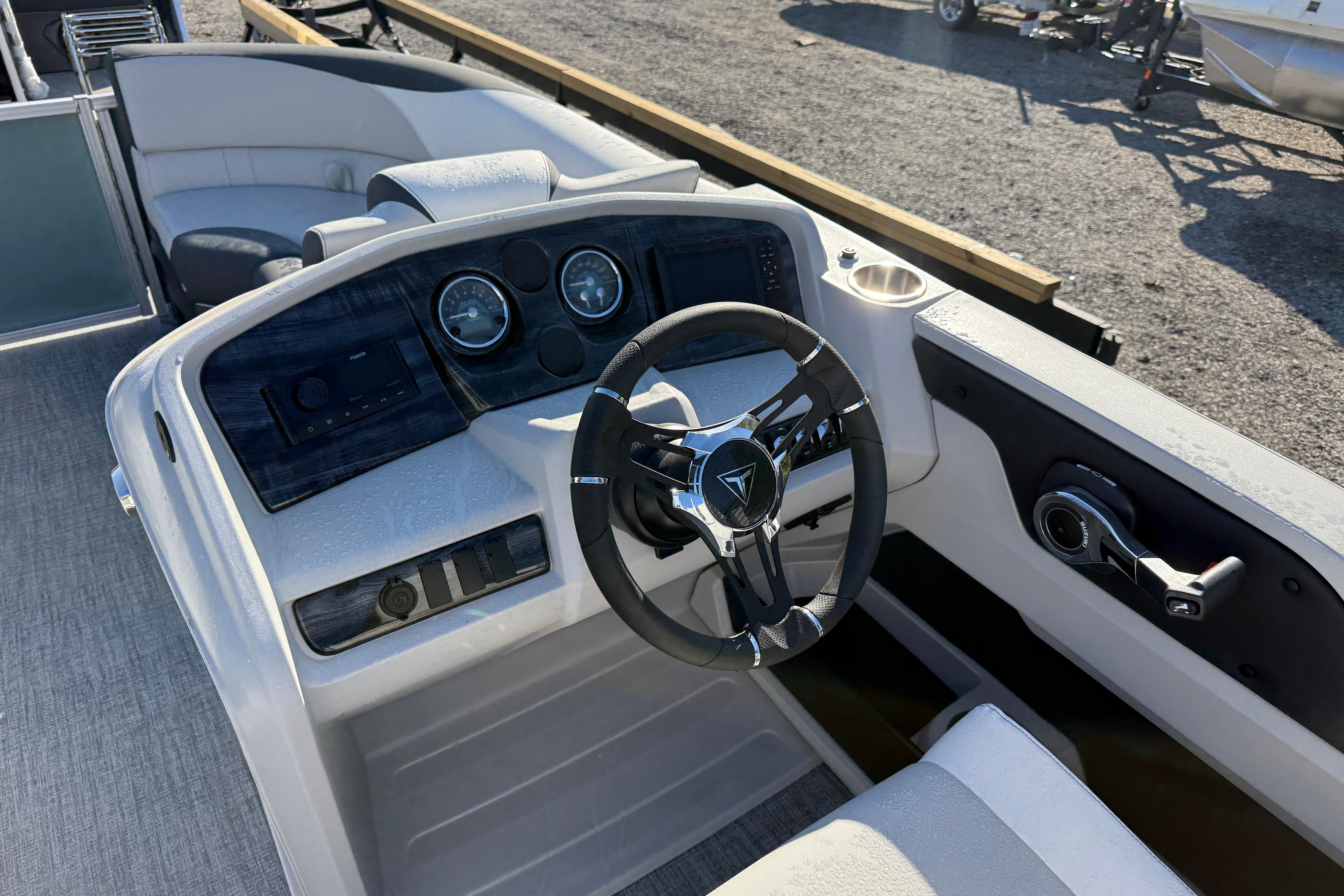 2026 Tahoe Pontoon LTZ Quad Lounger dashboard with steering wheel and controls.