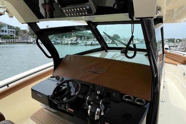 2020 Scout 420 LXF boat helm with modern controls, docked in a marina.