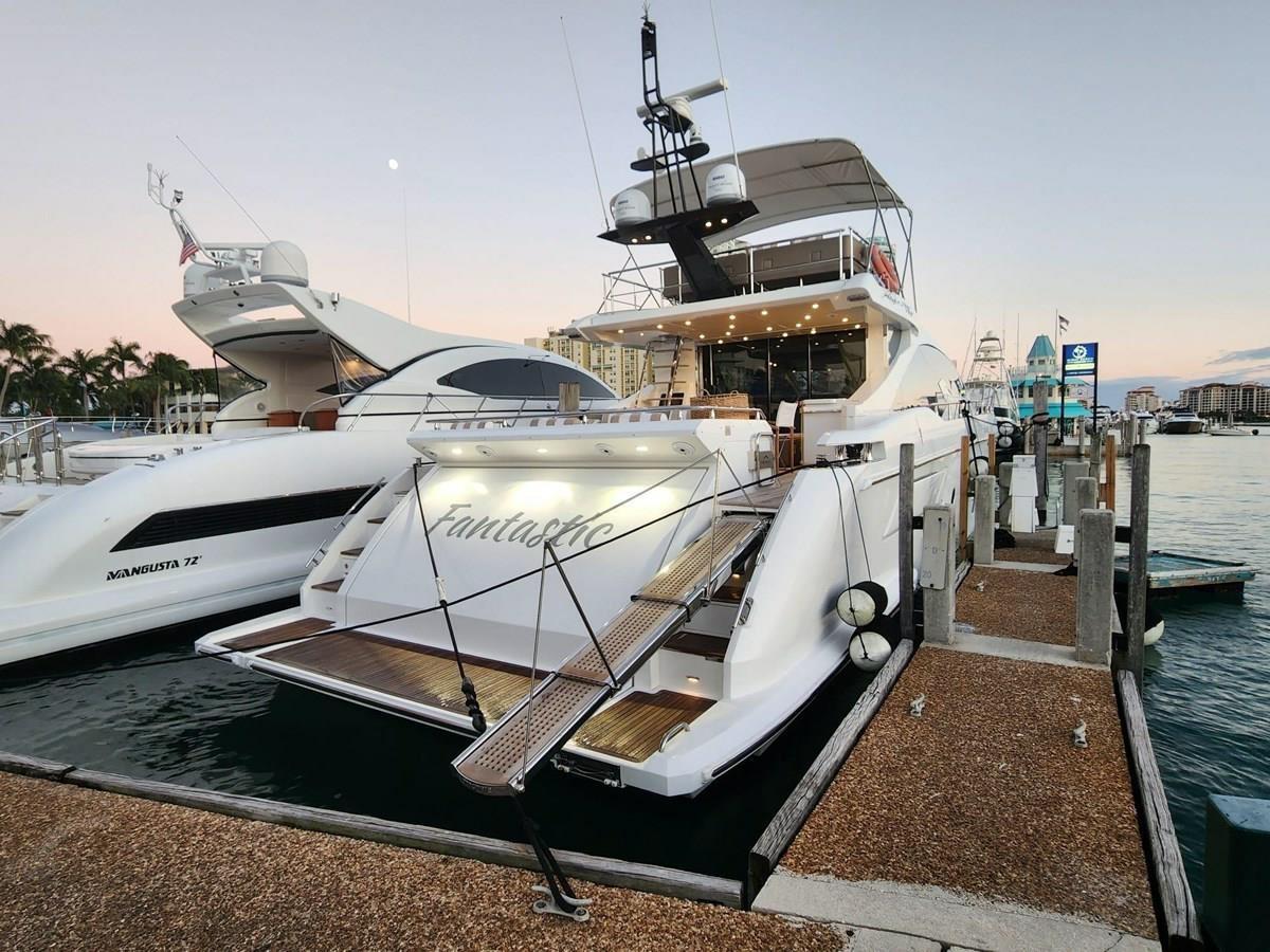 2019 Azimut 77S yacht docked at marina during sunset.