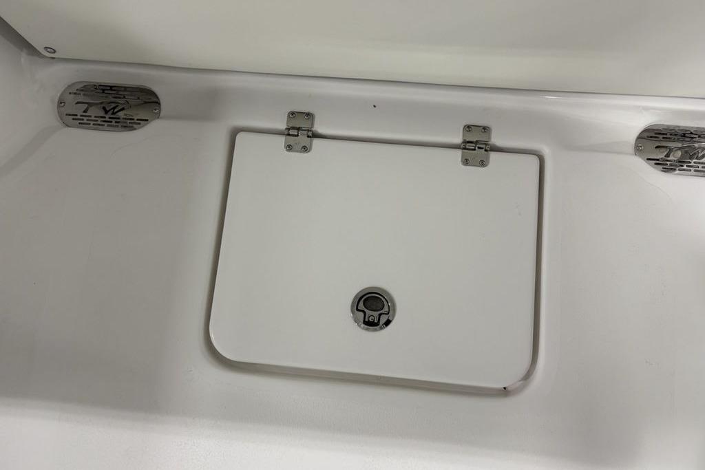 Hinged compartment on 2026 Tidewater 232 CC Adventure boat.