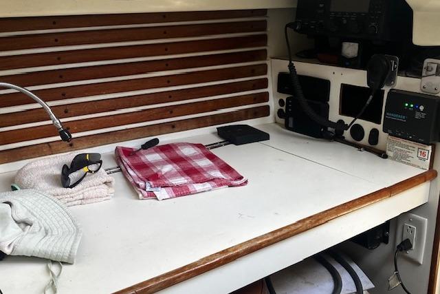 Navigation station on a 1979 Pearson 365 Ketch with radio equipment and accessories.