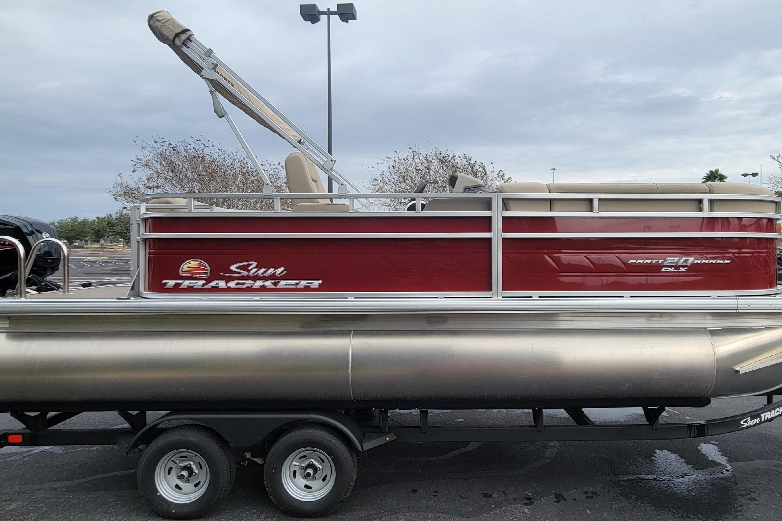 2025 Sun Tracker Party Barge 20 DLX pontoon boat on trailer, side view.