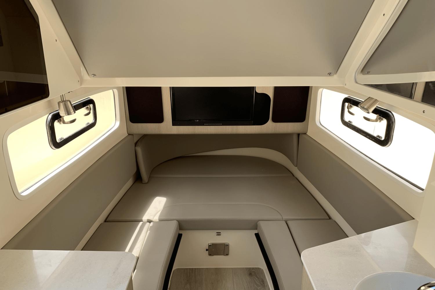 2024 Scout 357LXF cabin interior with seating, windows, and a mounted TV.