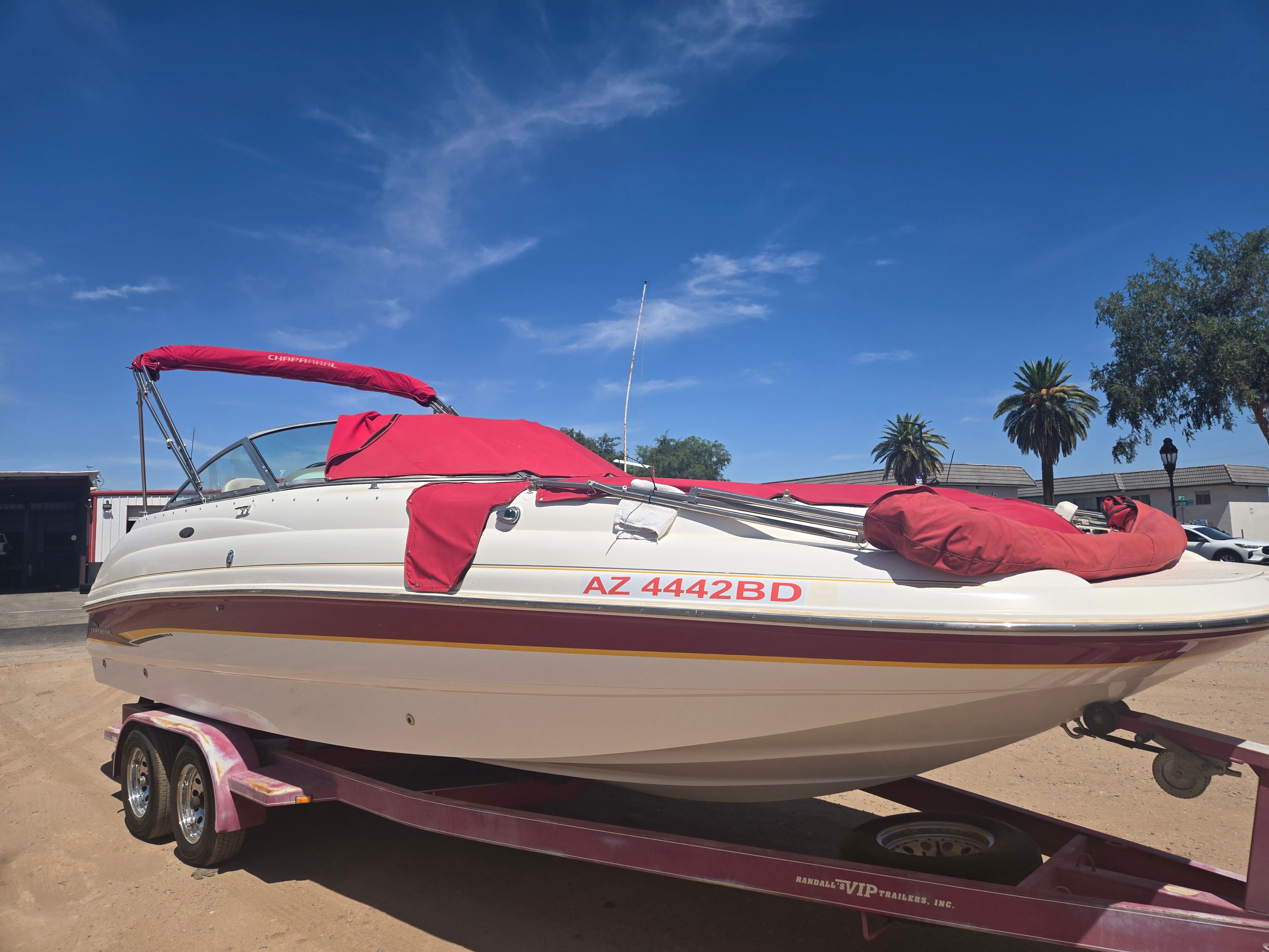 2001 Chaparral Sunesta 233 boat on trailer, red canopy.