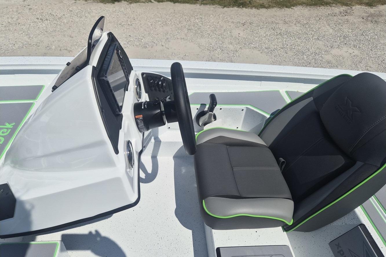 Cockpit of 2026 Xpress H18 boat with steering wheel and cushioned seat.