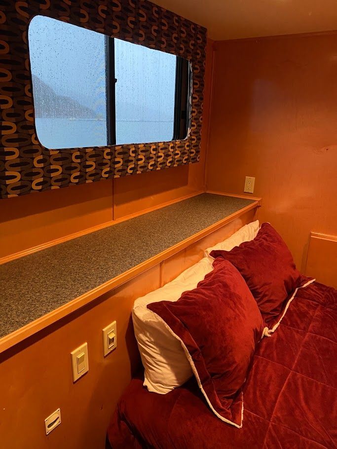 Interior of a 2006 Summersun Houseboats 16x68 with cozy bed.
