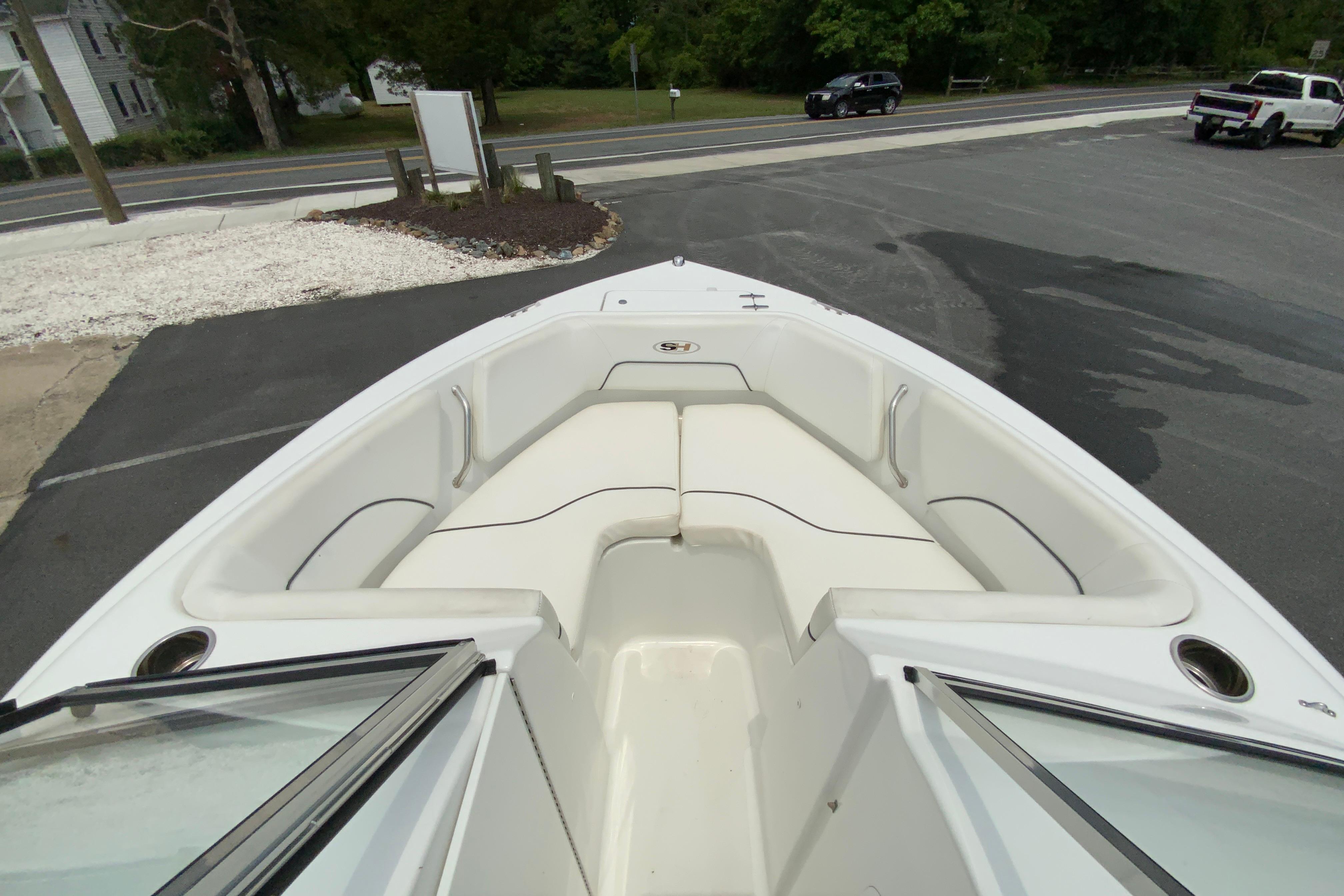 2014 Sea Hunt Escape 211 LE boat with spacious bow seating, parked in a lot.