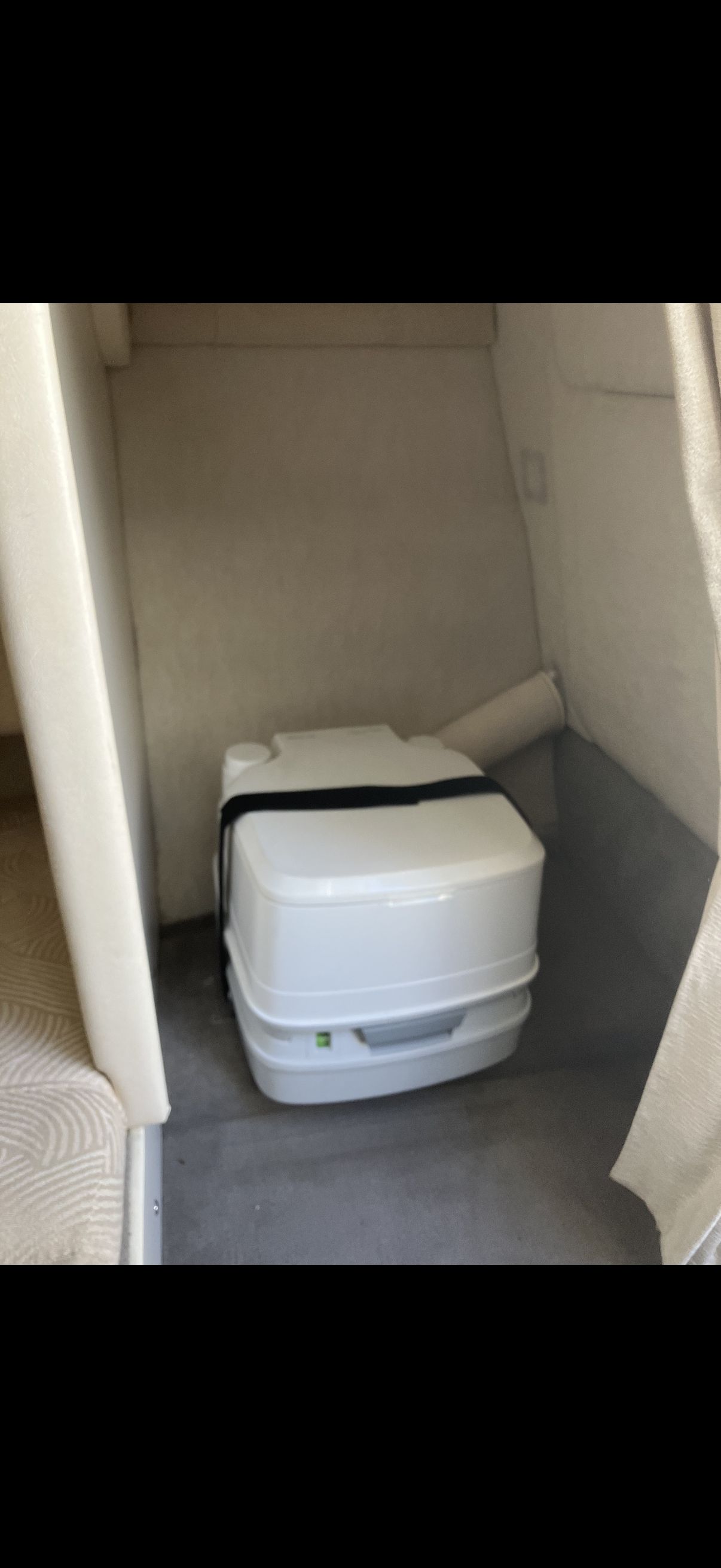 Interior of a 2007 Sea Ray 215 Weekender with portable toilet.