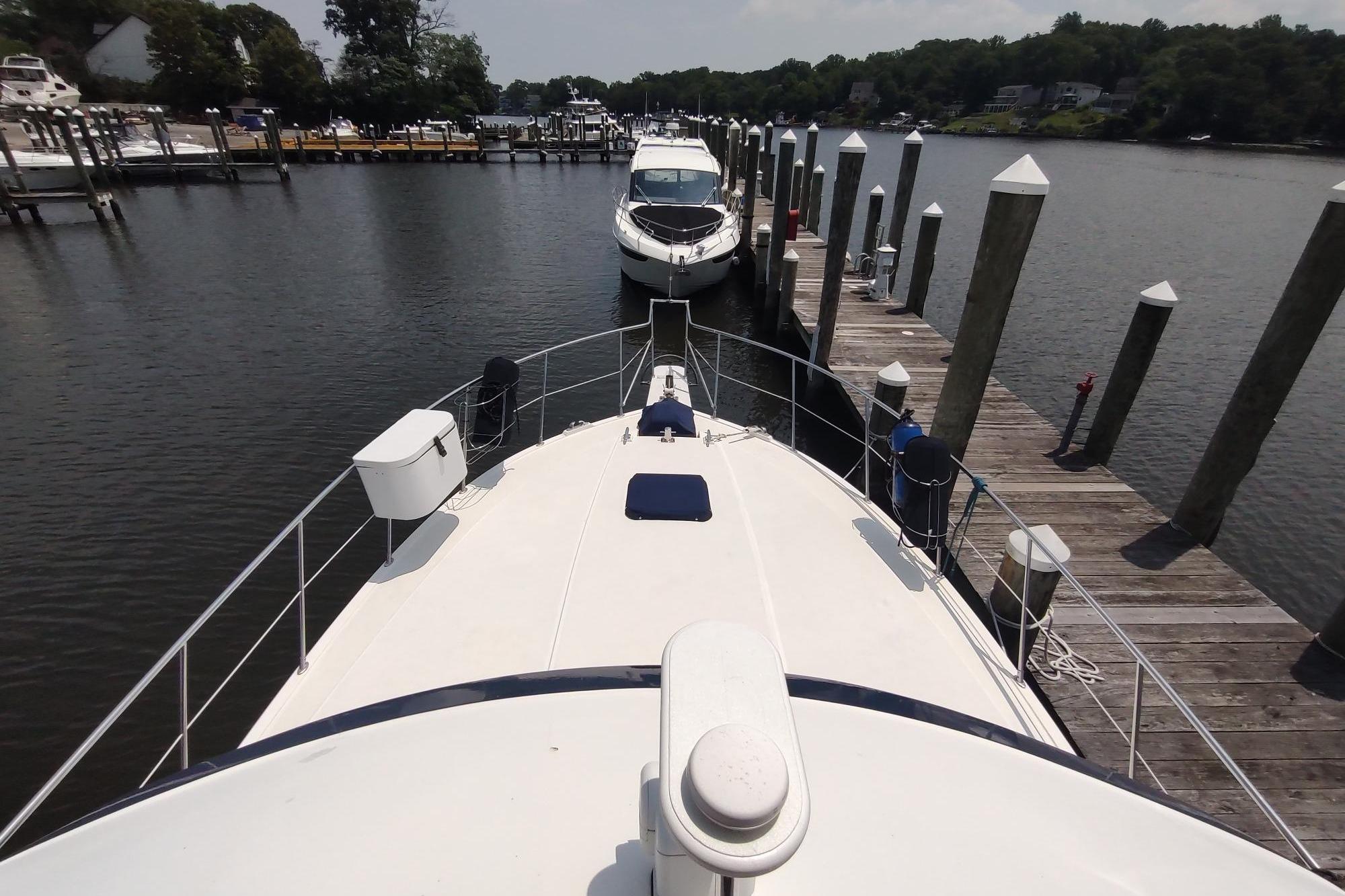 1989 Hyatt Double Cabin Motoryacht docked at a marina, surrounded by calm waters and piers.