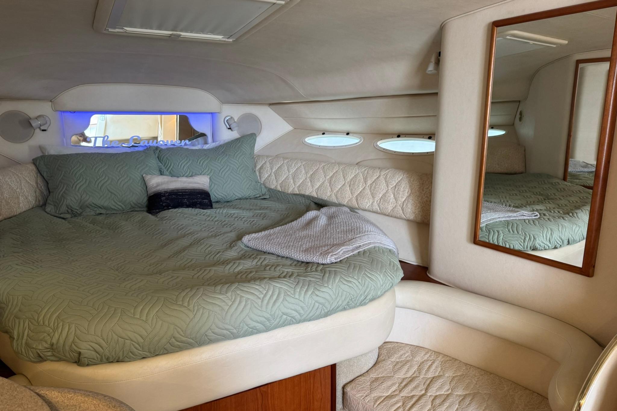 Luxurious cabin interior of a 2001 Sea Ray 340 Sundancer yacht with cozy bedding.