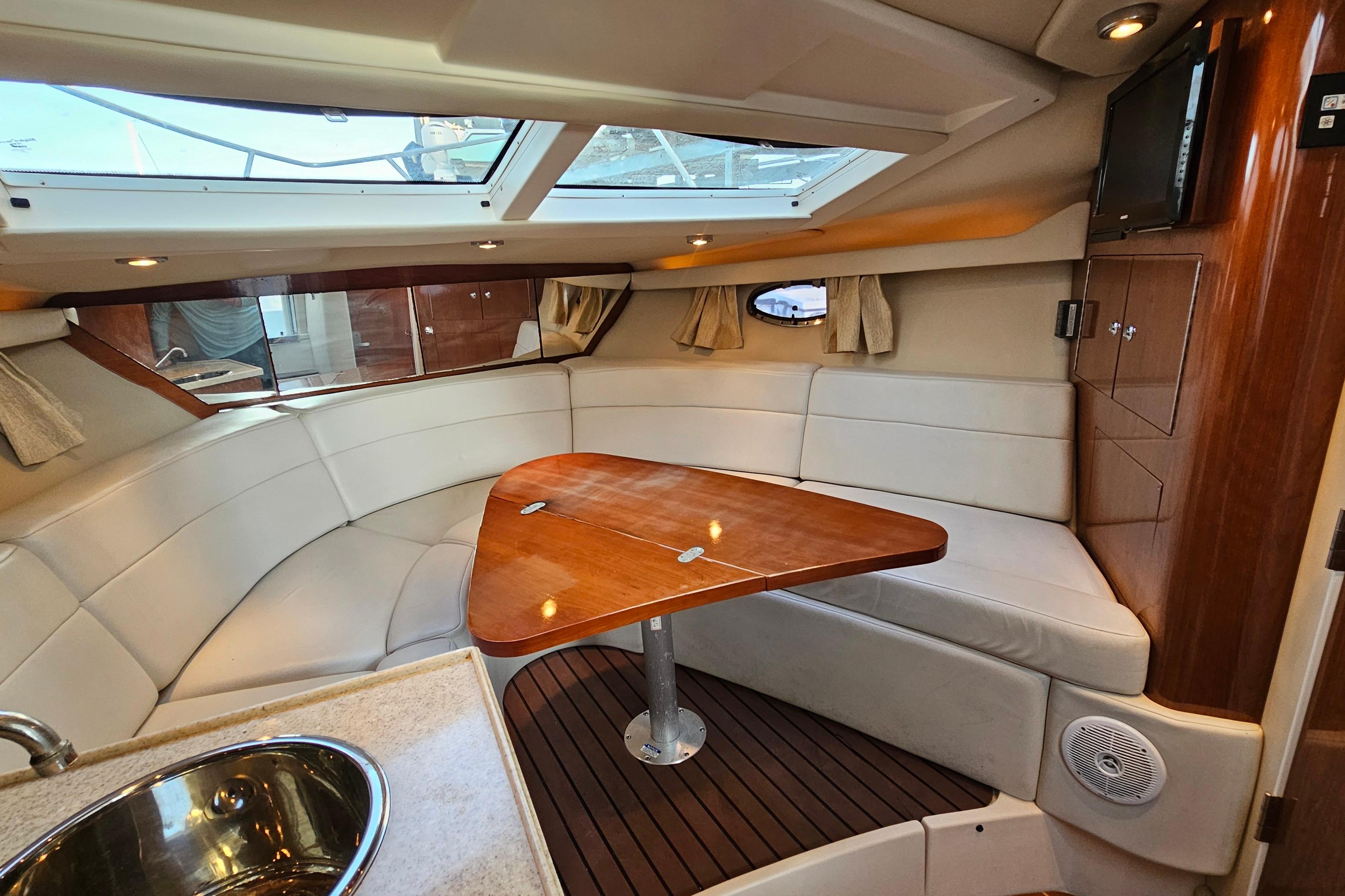 Interior of a 2005 Regal 3060 Window Express yacht with a cozy seating area.