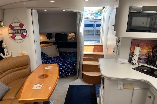 Interior of 1994 Cruisers Yachts 3675 Esprit with cozy seating and kitchenette.