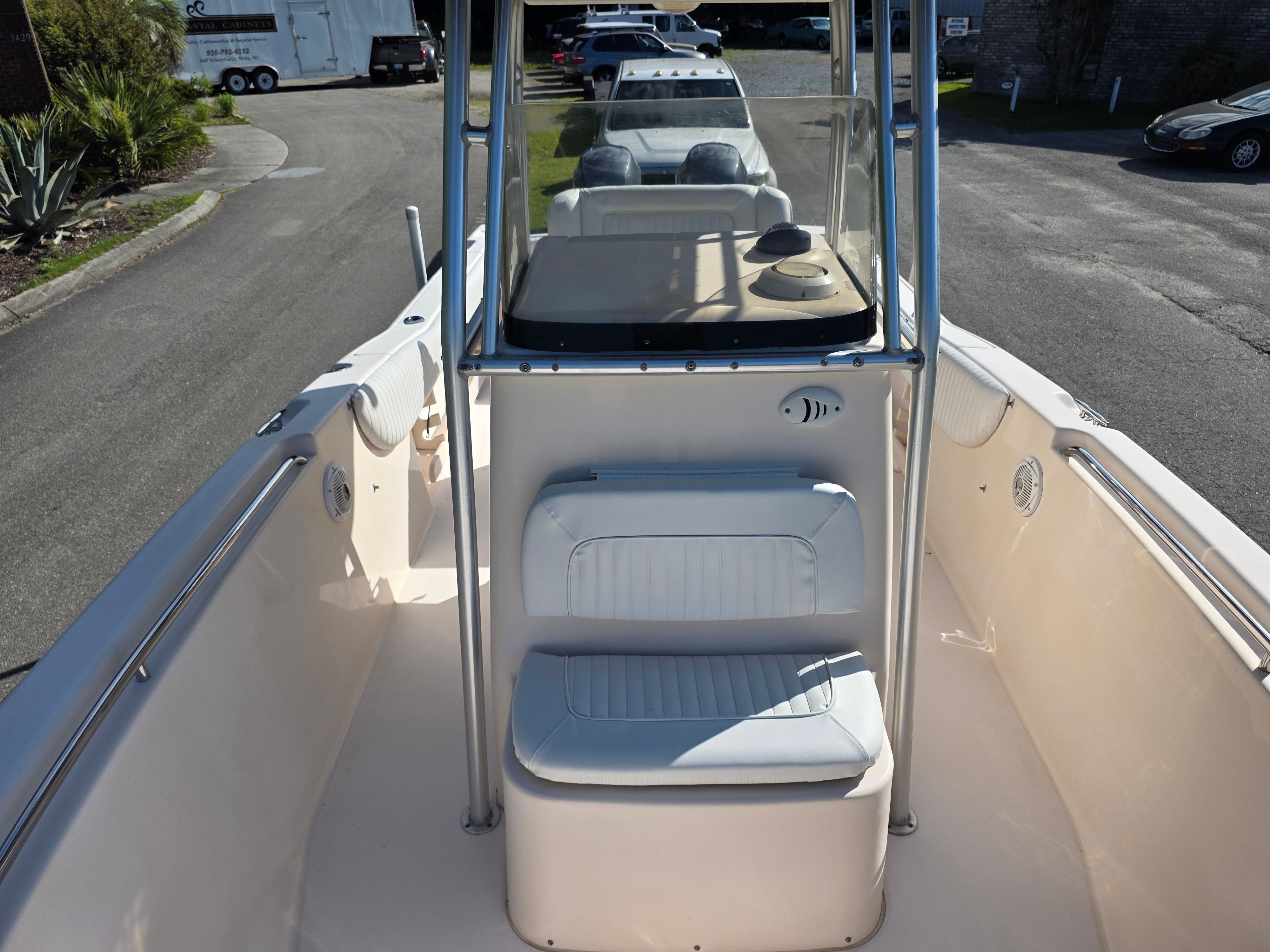 The image shows the cockpit of a 2006 Grady-White 257 boat with white seating and helm console.