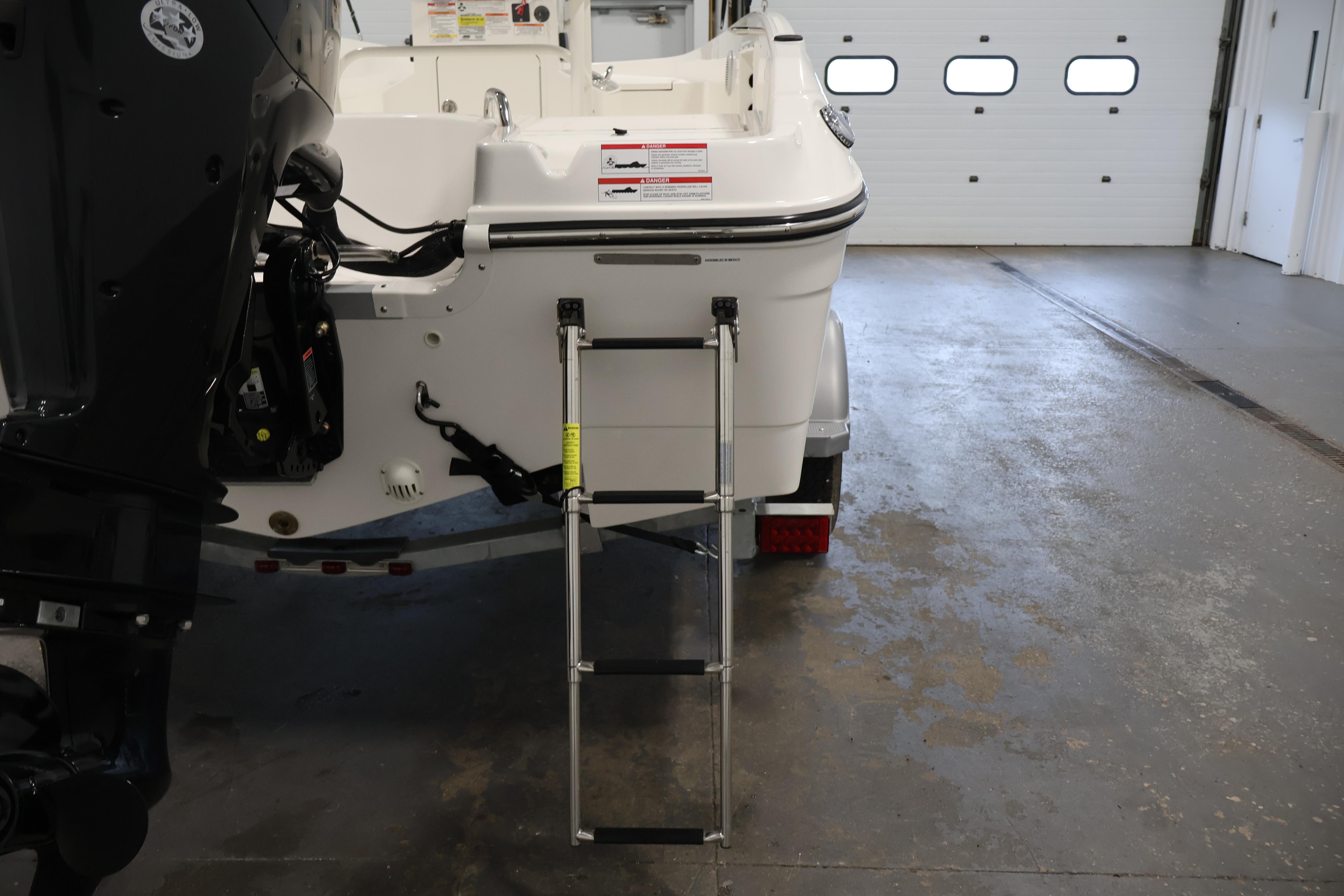 2026 Bayliner Trophy T18 boat with ladder in a garage setting.