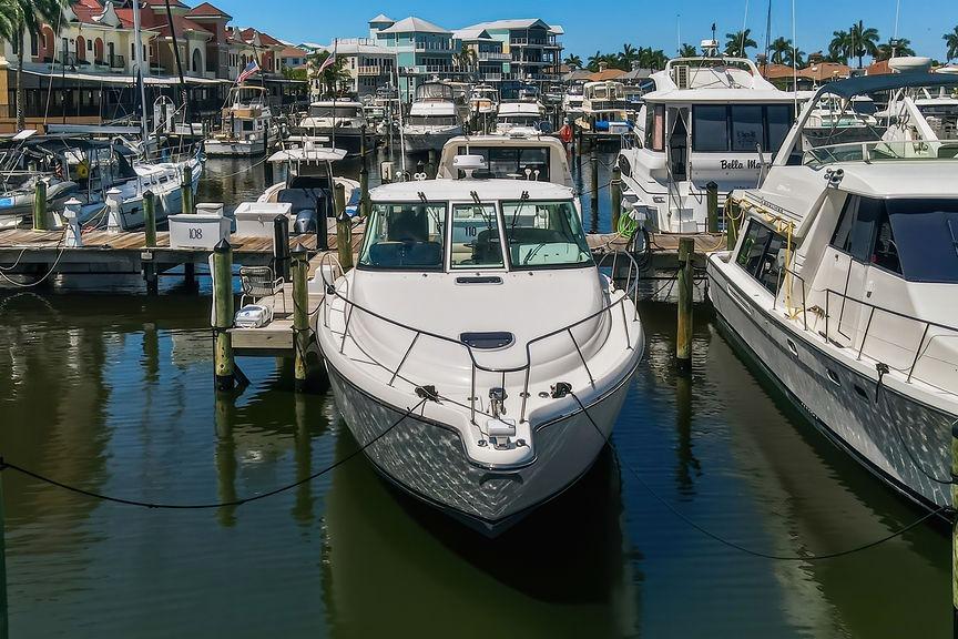 2008 Tiara Yachts 3900 Sovran docked in a bustling marina, surrounded by other boats.