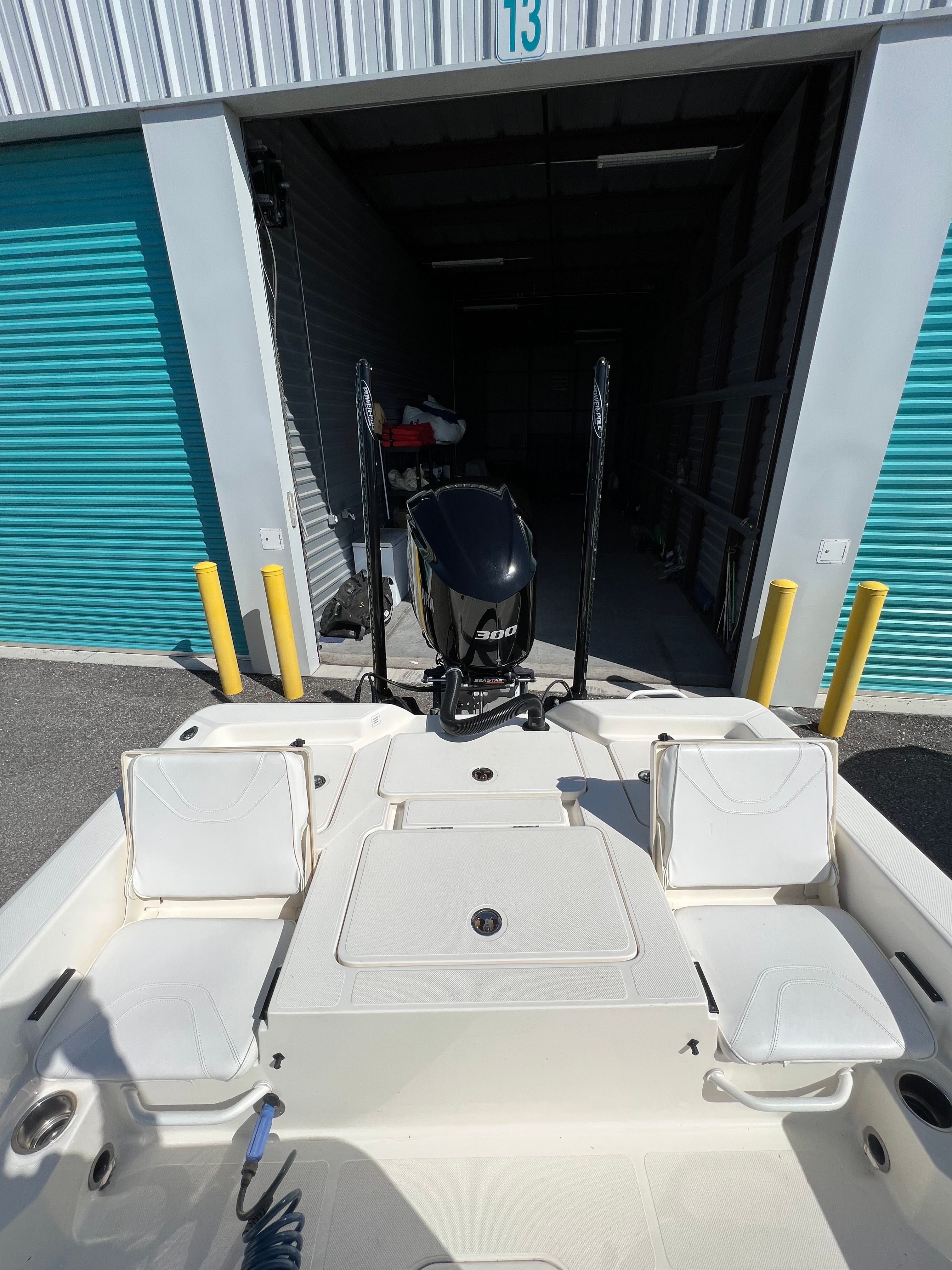 The image shows the stern of a 2020 Skeeter SX240 boat in a storage facility.