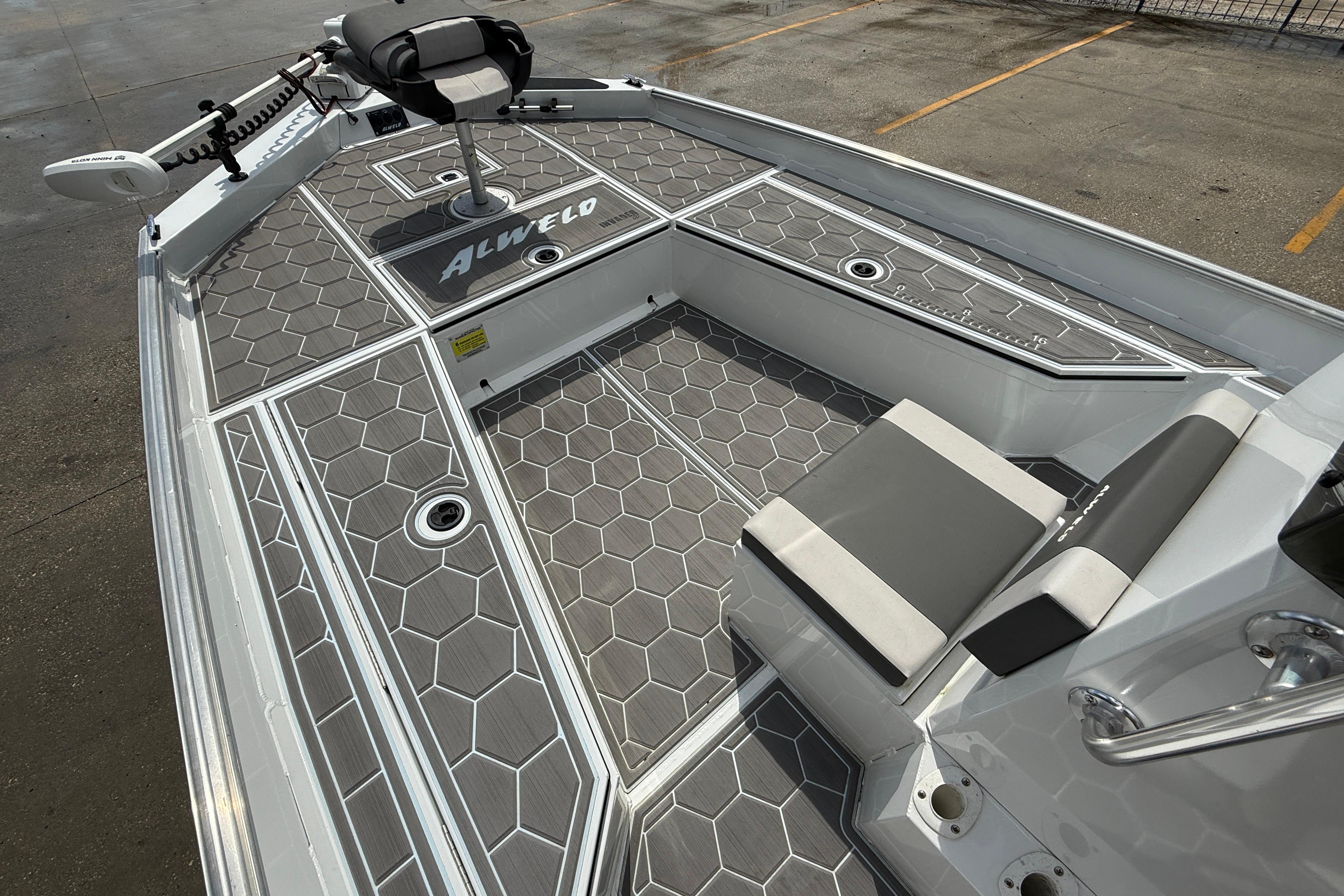 2024 Alweld 2070cc boat interior with hexagonal patterned flooring and seating.