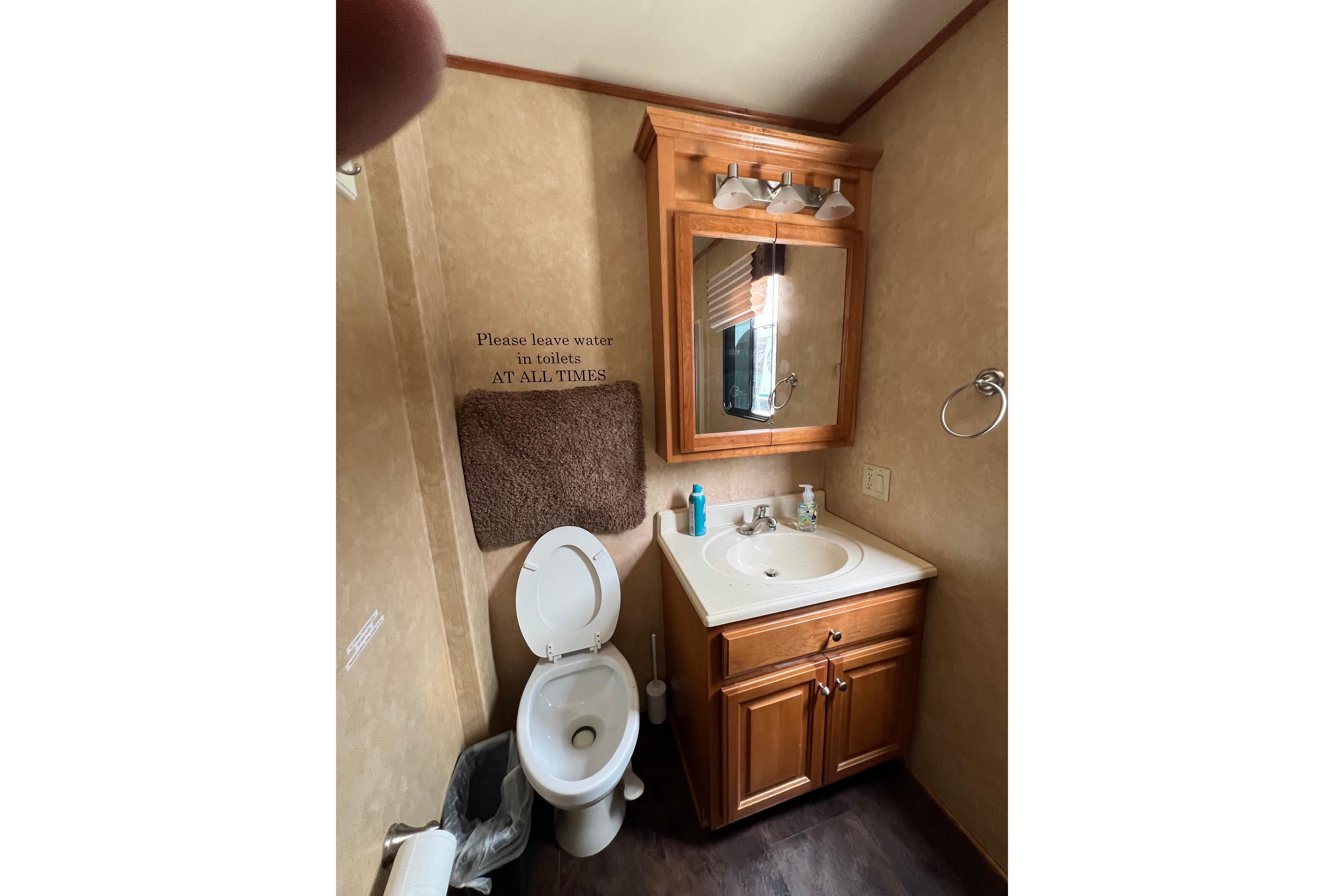 Bathroom interior of 2013 Destination Yacht Lotta Yachta with sink, mirror, and toilet.