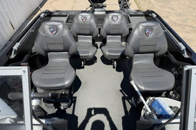 2016 Triton 216 Fishunter boat interior with four gray seats and fishing equipment.