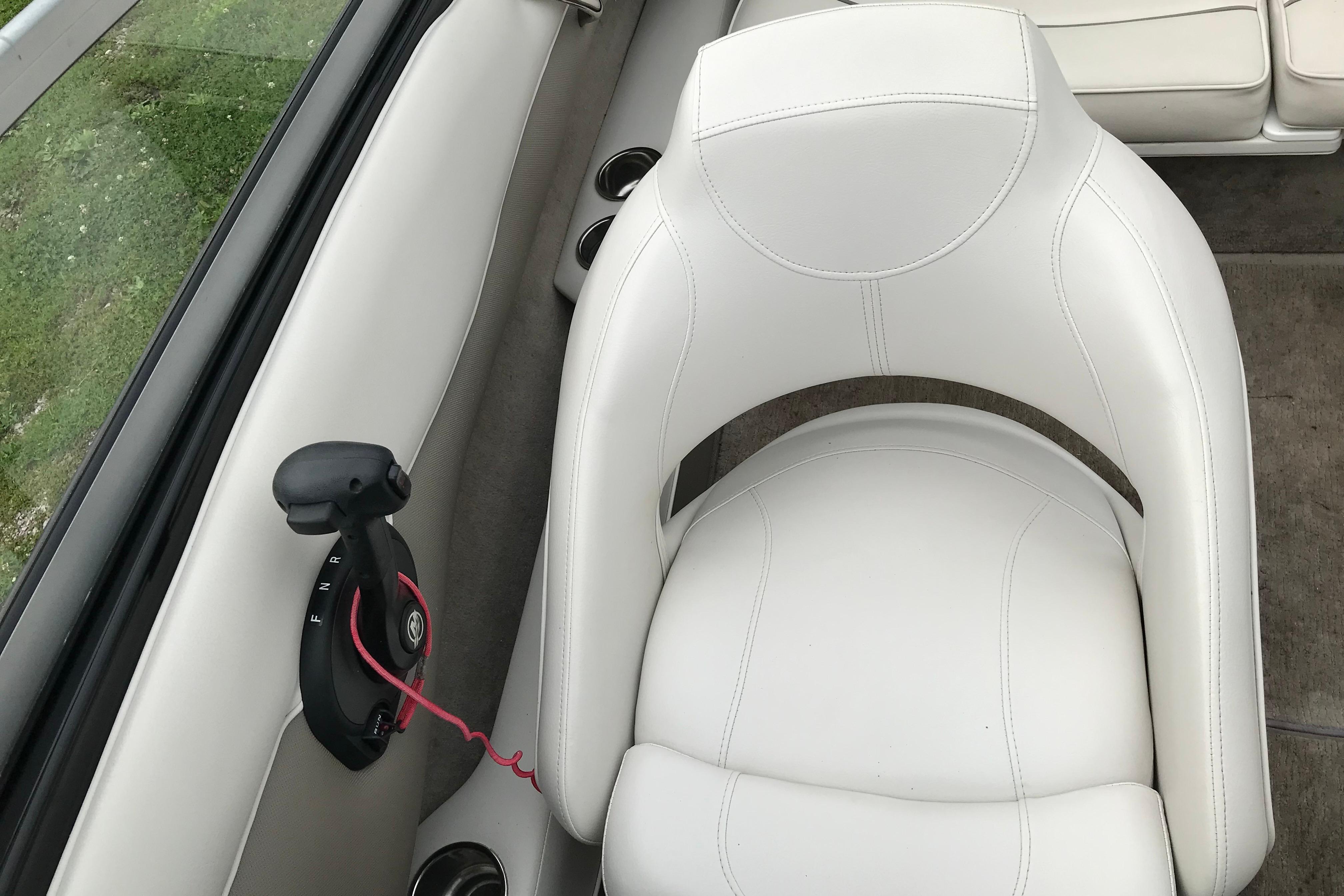 2015 Crownline 18 SS boat interior with white seating and control lever.