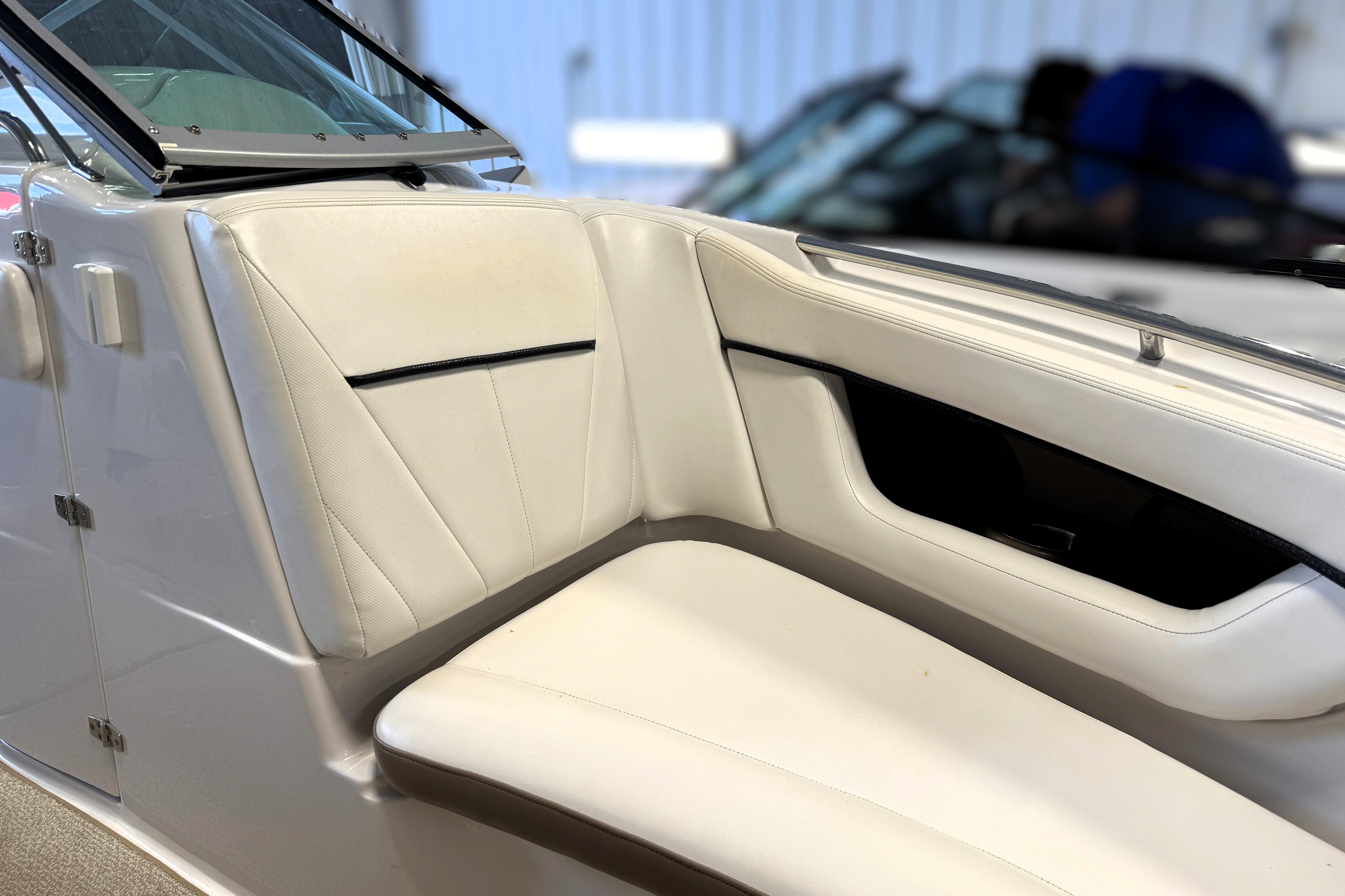 2008 Four Winns H240 boat interior with white leather seating and sleek design.
