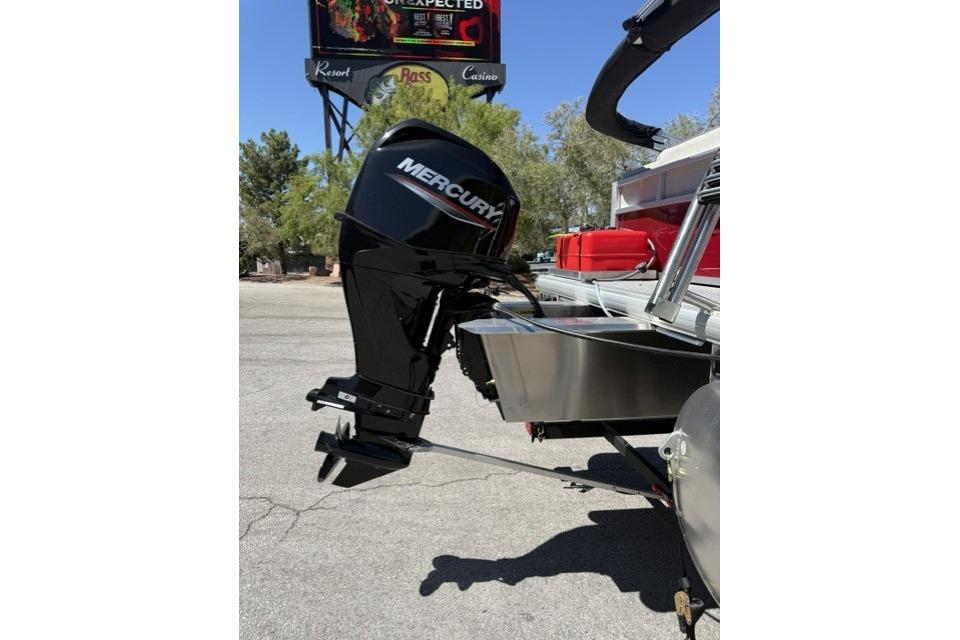 2026 Sun Tracker Bass Buggy 16 XL Select with Mercury outboard motor in a parking lot.