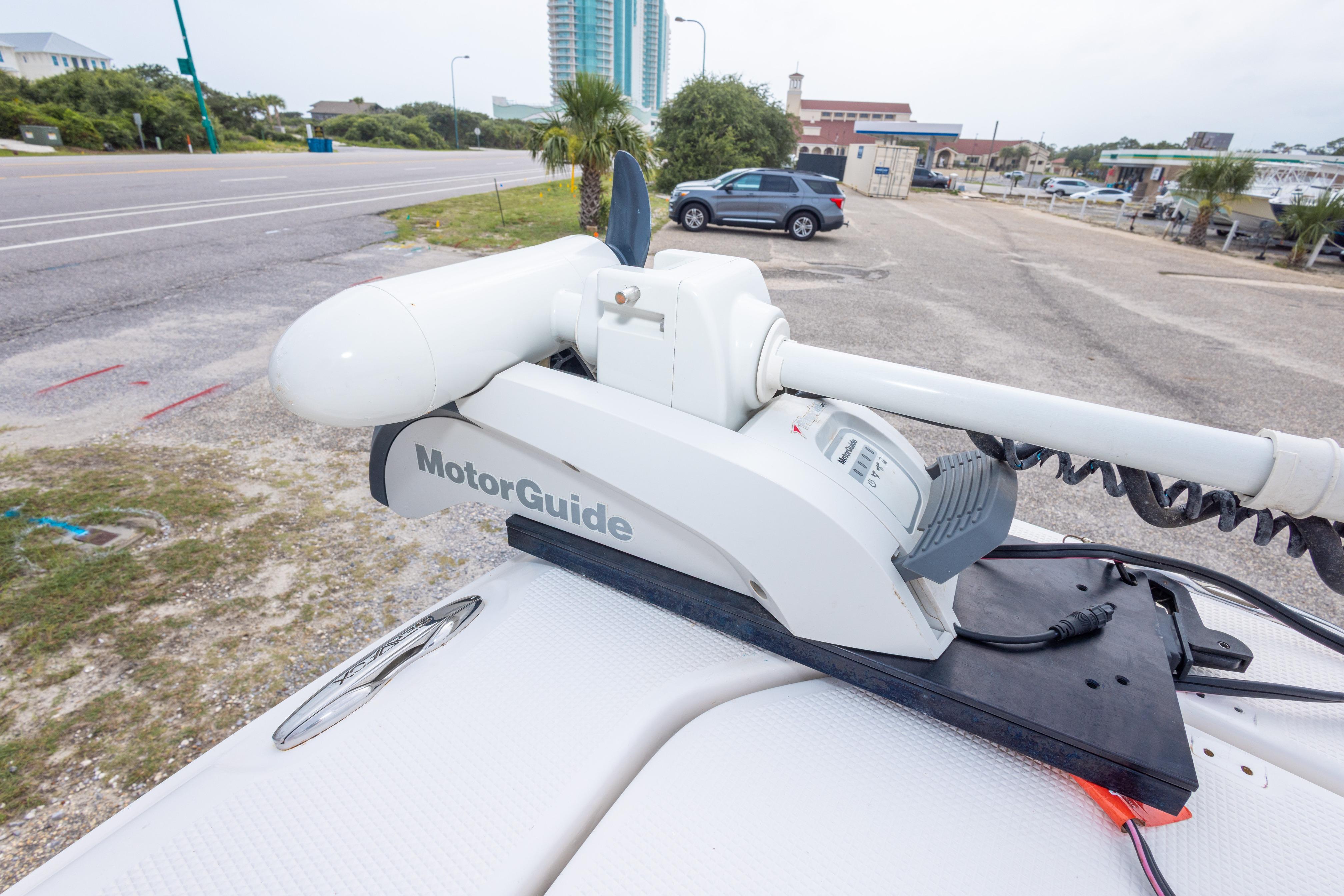 MotorGuide trolling motor on 2014 Sea Fox 209 Commander boat, parked near a road.