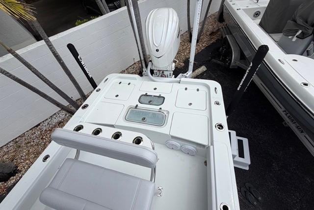 2025 Contender 26 Bay boat deck with seating and storage compartments.