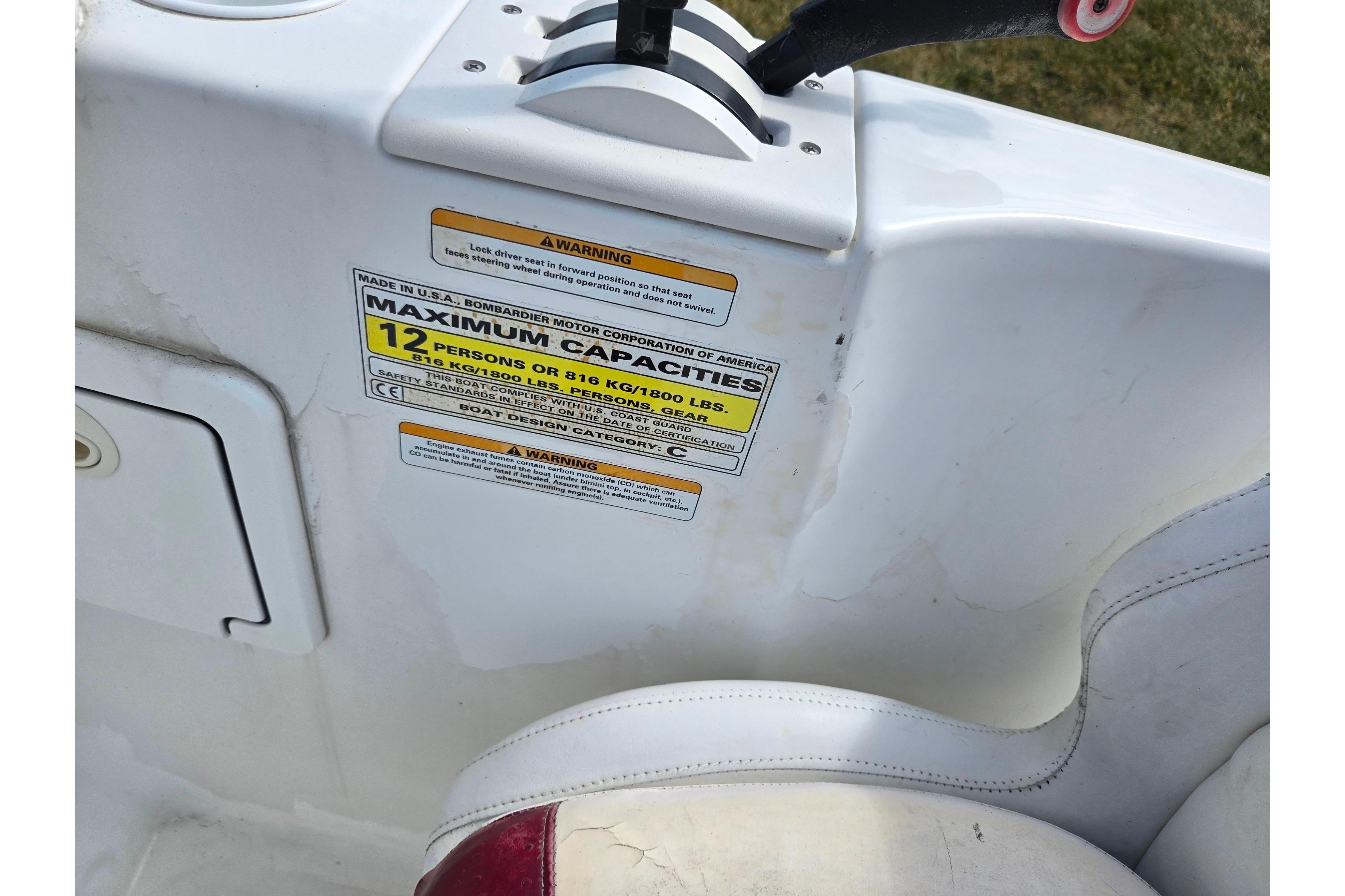 2004 Sea-Doo Islandia boat capacity label, seating for 12, white and red interior.