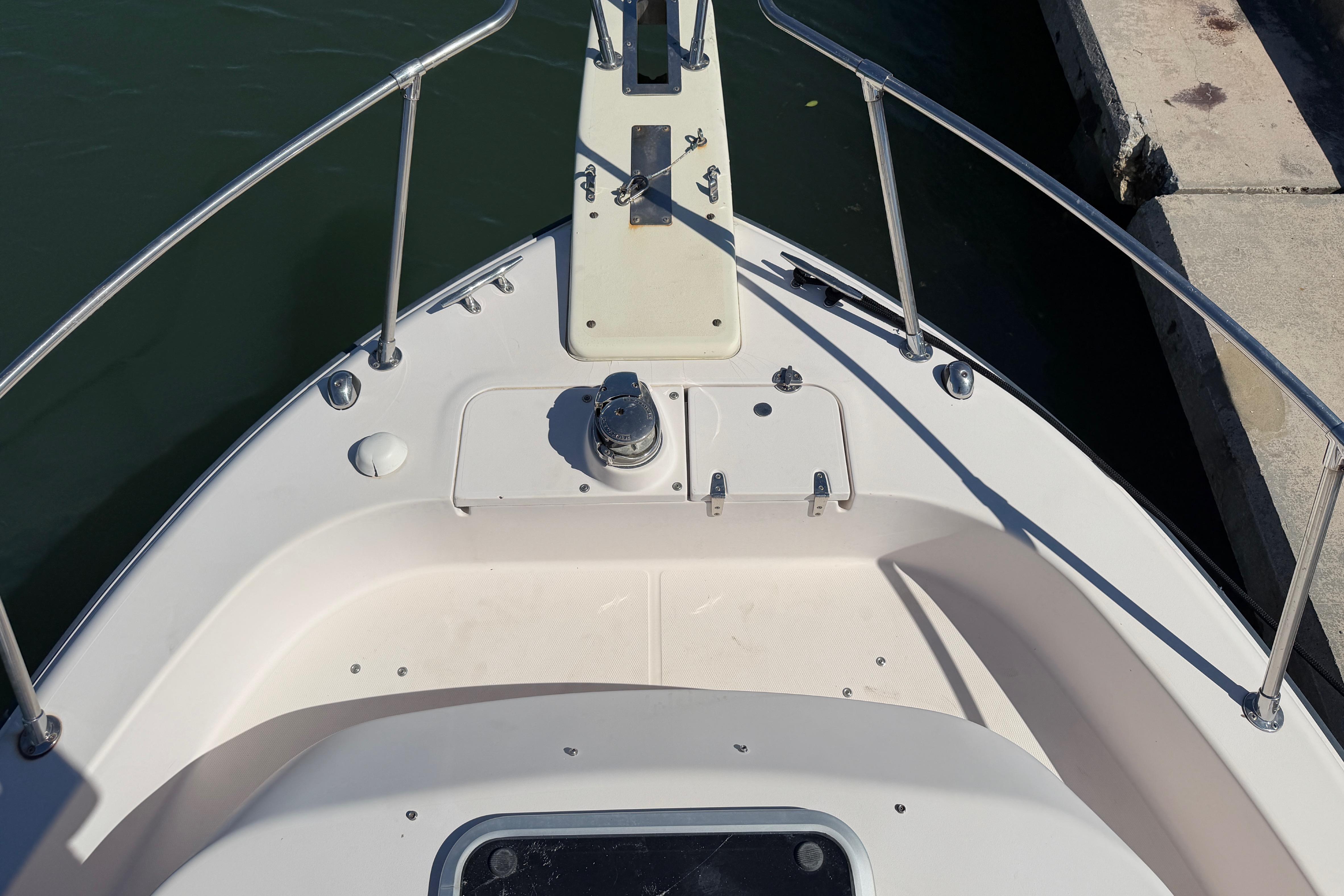 Bow of 2006 Grady-White Sailfish 282 boat docked, featuring anchor and railing.