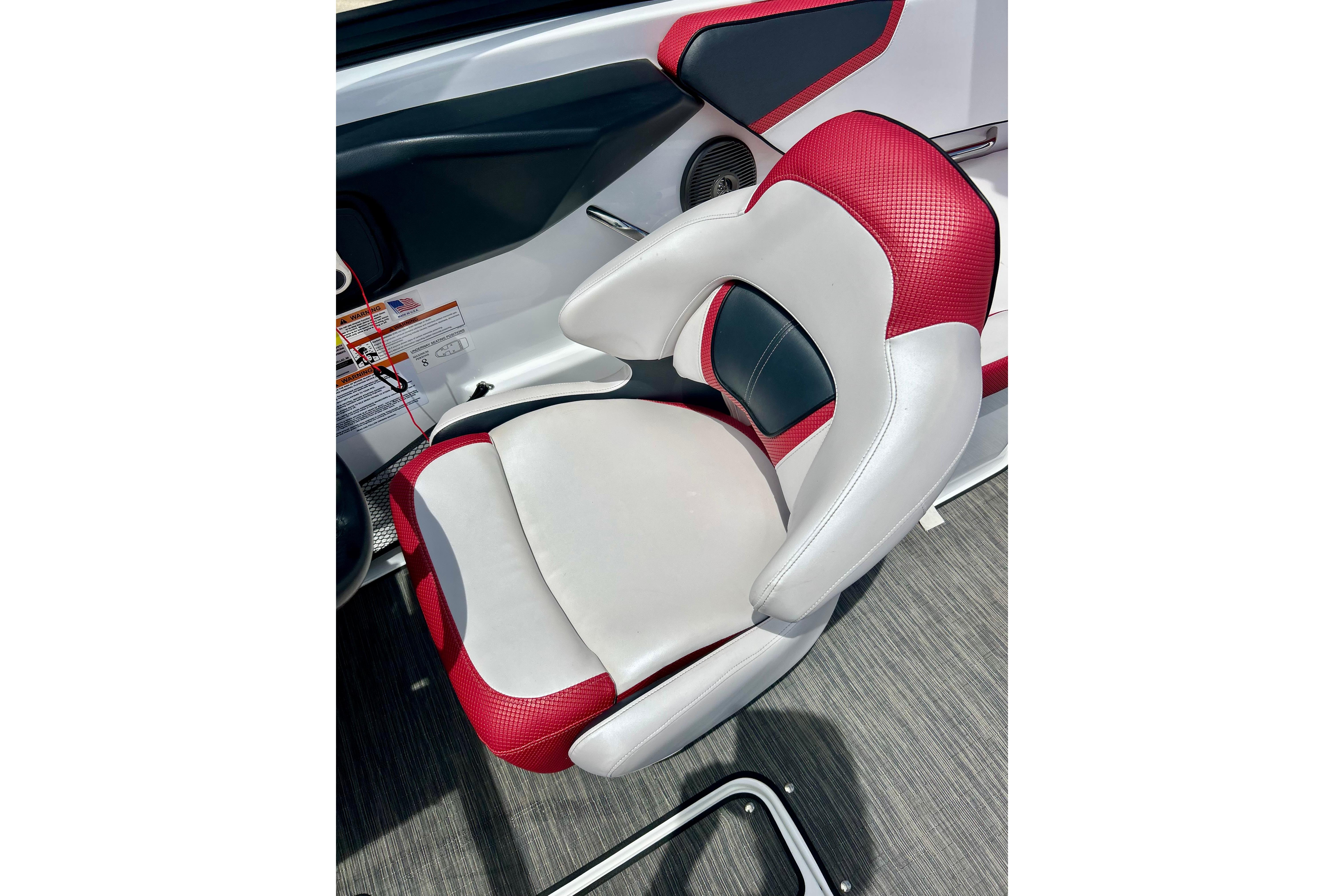 Red and white seat in 2021 Scarab 195 ID boat interior.