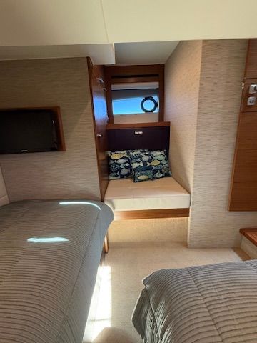 Interior of a 2017 Tiara Yachts C44 Coupe with cozy beds and cushions.