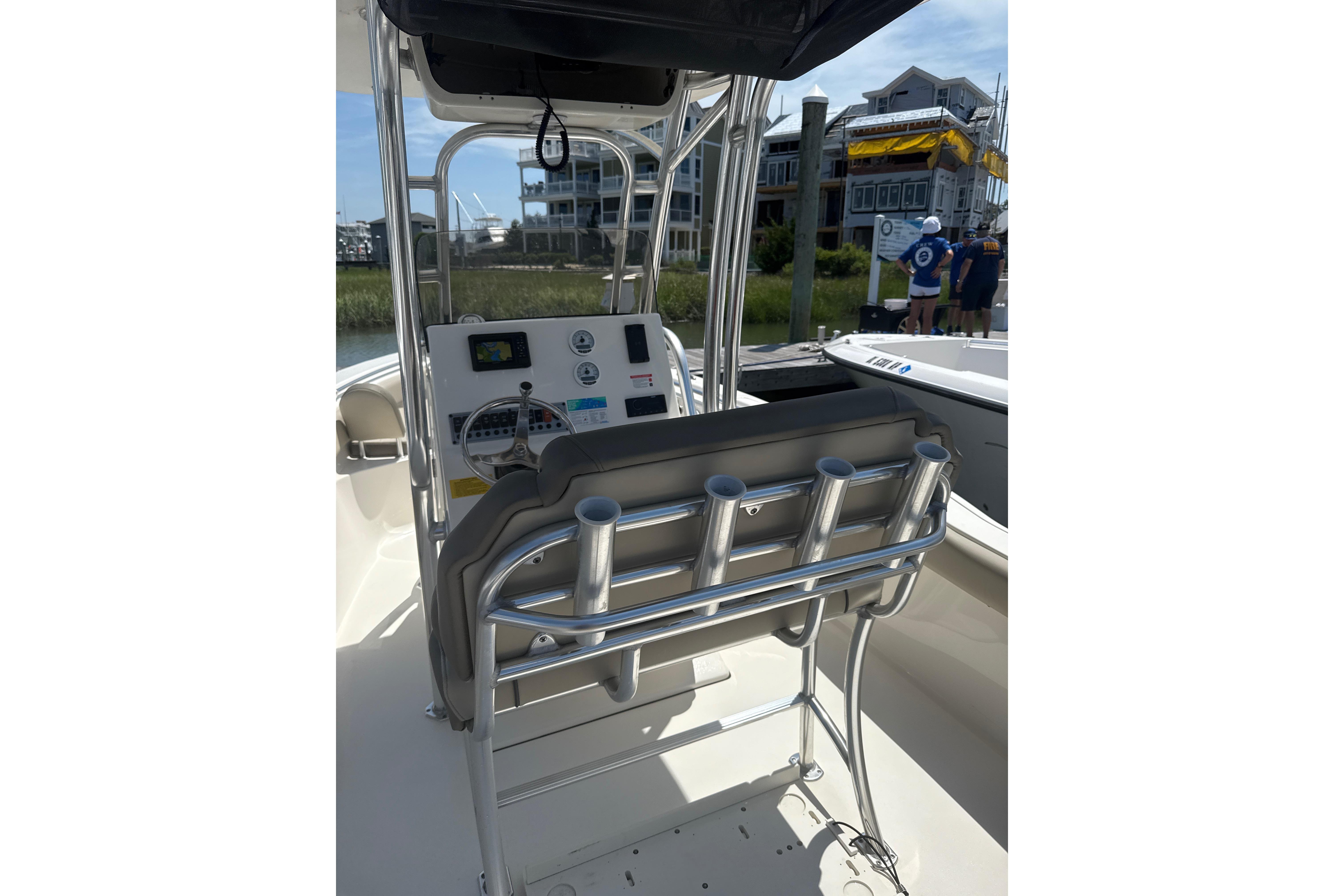 2024 Key West 239 FS boat interior with steering console and rod holders.